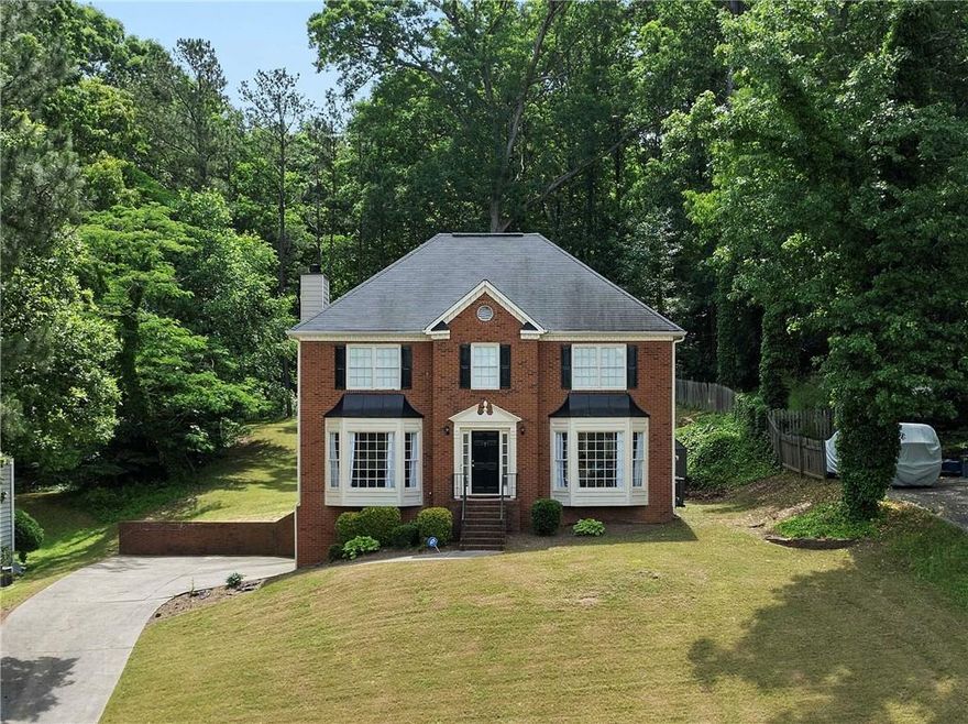 Introducing the perfect Marietta home for you and your family in a wonderful swim/tennis community! This 4-bedroom, 2.5-bathroom brick-front traditional home with a partially finished basement is designed to meet all your needs and more. The bright and airy main level, enhanced by bay windows, boasts a formal living room that seamlessly flows into a spacious fireside family room. The separate dining room features elegant crown molding and wainscoting, leading to a kitchen with granite countertops, stainless steel appliances (including refrigerator), and a cozy breakfast nook with views of the expansive backyard.

Enjoy outdoor living on the large deck, or take advantage of the oversized front and back yards and a driveway that offers ample parking. Whether you’re relaxing or entertaining, this home is designed for both comfort and functionality.

The oversized owner’s suite is a true retreat, featuring double tray ceilings and French doors that open to a spa-like ensuite. This luxurious bathroom includes double vanities, a soaking tub, a frameless glass shower with tile flooring and walls, and abundant natural light from multiple windows and a skylight. Upstairs, you’ll also find three spacious secondary bedrooms and a hallway bath for added convenience.

Bring your vision to life in the partially finished basement, perfect for a media room, home office, or playroom. The possibilities are endless!

Conveniently located just minutes from Marietta Square, Kennesaw Mountain, and the Silver Comet Walking Trails, this home offers easy access to outdoor recreation and natural beauty. With quick connections to I-75, I-285, and the East-West Connector, as well as nearby shopping and dining options, everything you need is within reach.

As a bonus, this property is located in a vibrant community with outstanding amenities, including a Swim/Tennis facility, sidewalks, and a competitive swim team. This home offers the perfect combination of lifestyle, location, and charm.

Don’t miss out on the opportunity to make this remarkable property your own. Your future begins at 3075 Milford Chase SW!
