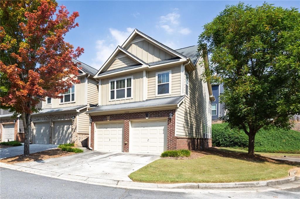 Welcome to this move-in-ready townhome located in the Highlands at Booth's Farm. This beautifully maintained 3-bedroom, 2.5-bath home features a 2-car attached garage and is nestled in a gated community offering resort-style amenities including a swim area and cabana. Step into a bright two-story foyer where elegant arched entryways lead to an open-concept floorplan, perfect for modern living. The living room and bedrooms feature brand new carpet, while the kitchen, foyer, dining room, and sunroom showcase rich hardwood flooring. The inviting family room centers around a cozy fireplace flanked by custom built-ins. The well-appointed kitchen boasts 42" cherry cabinets, stainless steel appliances, and hardwood floors. Upstairs, you'll find a spacious primary suite complete with a sitting area, vaulted ceilings, an oversized walk-in closet, and a luxurious bath with double vanities, a garden tub, and separate shower. Two generously sized secondary bedrooms share a full bath and are conveniently located near the laundry room. Enjoy quiet evenings on your private back patio. This end unit townhome sits in a quiet cul-de-sac adjacent to the overflow visitor parking. With exterior maintenance, landscaping, and trash removal included in the HOA, you can truly enjoy low-maintenance living just minutes from Downtown Marietta, shopping, dining, and quick access to I-75. Don’t miss this opportunity to own in a prime location with exceptional value!
