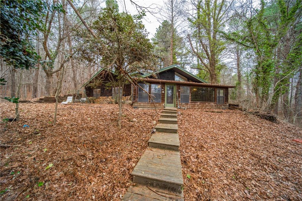 Get away from all the hustle and bustle with 17.1 Gorgeous acres of private land with two large ponds. As you enter the property on the tree-lined driveway... be sure to bring your imagination to either invest in a complete renovation of the existing home or build the home of your dreams! The existing home was built in 1985 and has great potential!! Hardwood floors, open floor plan with views of the water from kitchen and family room. 3 Bedrooms with a flexroom that can be a bedroom, 2 full baths, walk in Closets, vaulted ceilings, skylights. Huge cedar sunroom on back of home overlooking the water. Detached garage, storage sheds, wooden walkway to lake and a large tanning/party deck. Home needs complete renovation but with some work it could be brought back to FABULOUS!! No HOA. Sold As-Is. You need to see this incredible piece of land in person!