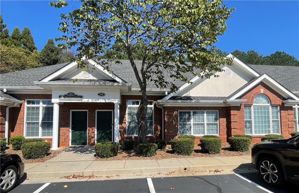 This attractive single-story office has been freshly painted throughout and features new laminate flooring and a modern bathroom vanity, offering a clean and professional environment ideal for any business. The well-designed layout includes a welcoming entry/reception area with a high tray ceiling, four executive-sized offices (or three offices and a conference room) as well as a dedicated printing/storage room, along with ample storage for supplies and larger office equipment providing flexibility for a variety of professional uses. The suite also includes a private bathroom, a bar sink, and a designated area for a coffee maker and microwave. Rent includes water, sewer, trash, exterior maintenance, and property taxes, ensuring a hassle-free leasing experience. We respond promptly to all showing requests. Located in a prime area with easy access to GA 400, Downtown Roswell, and the East Cobb Johnson Ferry commercial corridor, this is a rare opportunity to lease a well-maintained, single-story office in one of the region’s most desirable markets.