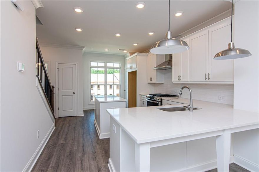 Spring into a New Home with The Providence Group! Discover luxury living in this beautifully crafted townhome that seamlessly combines modern elegance with everyday comfort. This home is designed for effortless, stylish living. From the moment you arrive, the private front entry, fenced yard, and covered terrace create a warm and welcoming first impression. Inside, the entry-level flex space serves perfectly as a home office or media room. Upstairs, the heart of the home awaits in the open-concept living area with an Electric Linear Fireplace, a stunning kitchen featuring a large island with Calacatta Lavasa Quartz countertops, 42” White cabinets with crown molding and soft-close doors, and premium GE stainless steel appliances. Step out onto your private wooden deck and enjoy seamless indoor-outdoor living. The top floor hosts a luxurious owner’s suite, a second spacious bedroom with a full bath, and a convenient laundry closet. IveyBrooke is just a short drive away to Avalon, Downtown Alpharetta dining, Top Golf, The Cooler, and more. Additional highlights include a one-car garage with EV charger, driveway parking, and ample guest parking throughout the community. Located in the heart of Alpharetta, this home offers the perfect mix of luxury, location, and lifestyle. Home is under construction. Photos and Virtual Tour are of previously built Barnsley Plan. Estimated completion July/August 2025. [The Barnsley I]