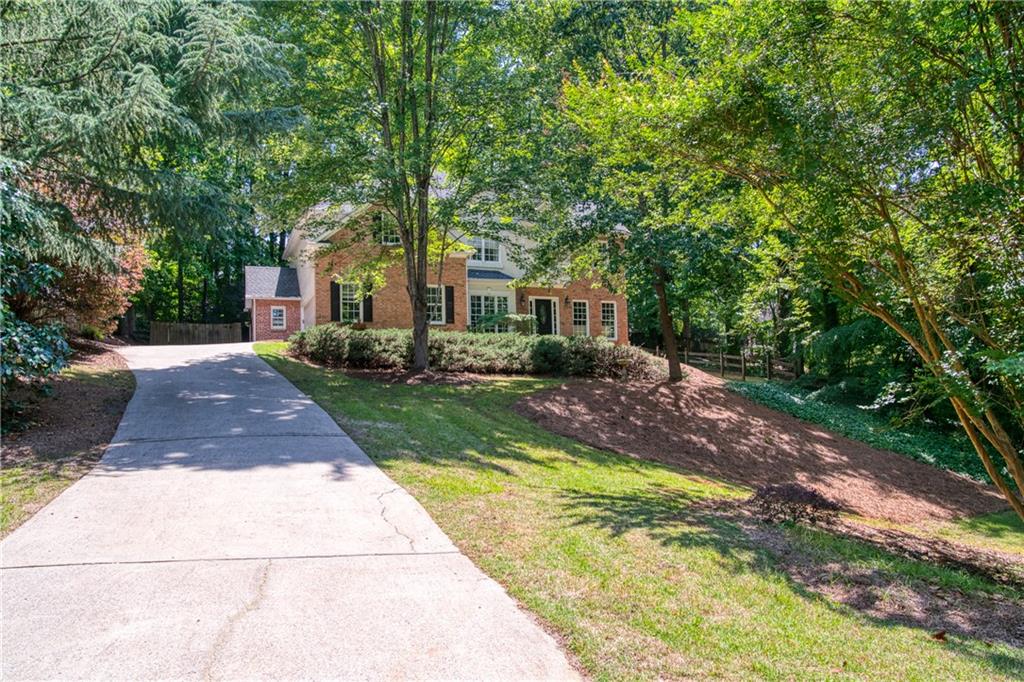 Lambert school district! Wonderful updated custom-built home on a private 0.63 acre cul-de-sac lot. Great primary suite with walk-in closet, tray ceilings, bath with jetted tub, huge tiled shower and dual vanity with vessels sinks. Dramatic two-story family room with stacked stone fireplace and wall of windows. Fenced backyard and separate fenced side yard. Chef's eat-in kitchen with granite, stainless appliances and bar. Dining room and living room overlook the picturesque front yard secluded from the street. Hardwood floors throughout the main floor. Side entry garage. Low Forsyth taxes. Preferred Closing Attorney Ashway Law, Cumming. Multiple offers - please present highest and best offer by 4pm Sunday, May 21st.