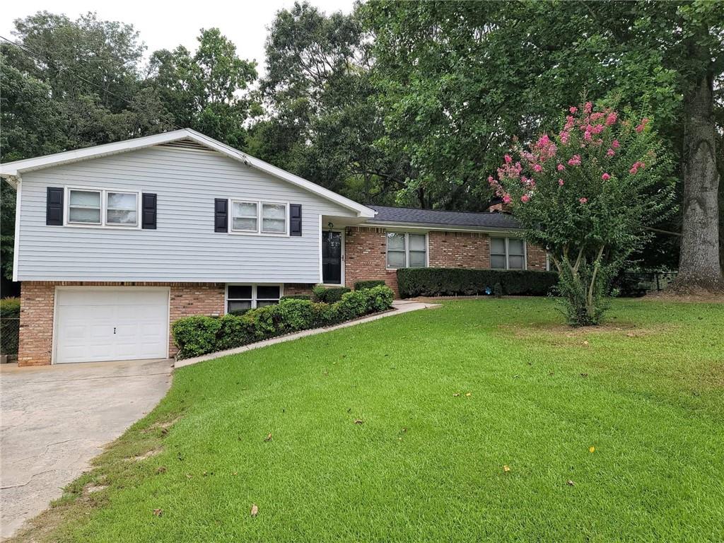 Spacious 3 bed, 2 bath home near Downtown Woodstock! This home features an open-concept main living area with durable LVP flooring throughout. The kitchen includes white cabinetry with ample storage, stainless steel appliances, and butcher block countertops, and overlooks the living room with a striking brick fireplace. Generously sized bedrooms and a beautiful, fenced backyard with an outbuilding.