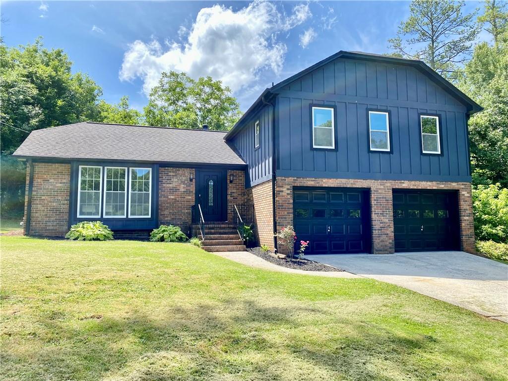 This split-level home with open concept has been completely renovated to perfection. Renovations include all new windows, hardwood floors throughout, new kitchen cabinets with quartz counters, new baths, and more. The quality and attention to detail is rarely found in homes at this price level. The kitchen features an oversized island with quartz countertops, stainless steel appliances, range hood, and Shaker style cabinetry. Family room has a real masonry fireplace. Upstairs has 4 BR, including the spacious primary bedroom which has his/her closets and a connected bathroom with new shower, double vanity, and quartz counters. Step out back to a large, private yard featuring a patio and storage bldg on a large lot with plenty of privacy. This is a modern renovation of a traditional home. Big BR with big closets. You'll love it.