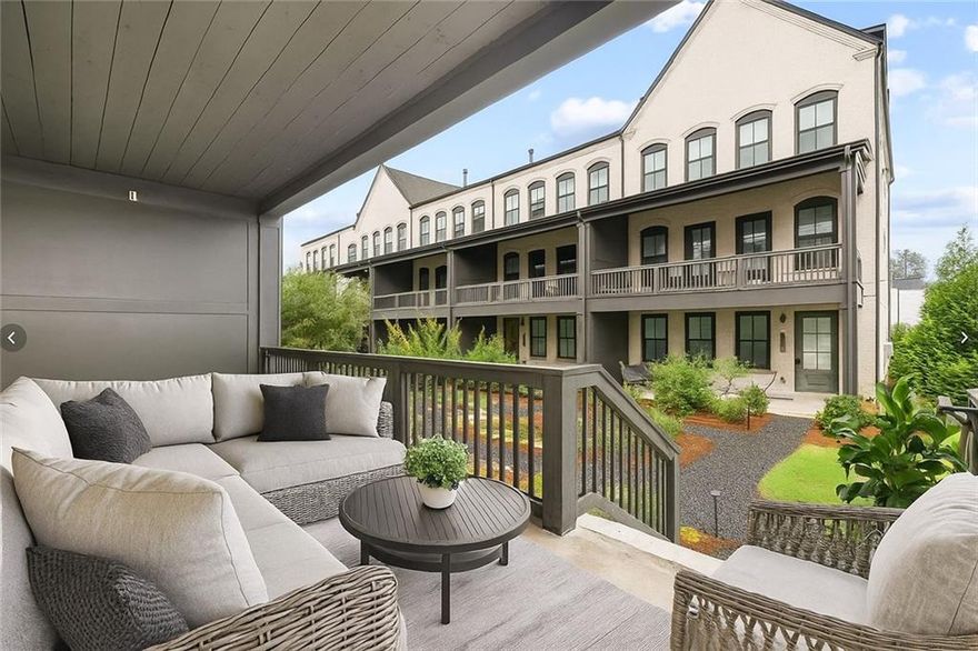 Welcome to effortless, luxury living in Halcyon—Alpharetta’s most vibrant and walkable community. This beautifully appointed end-unit townhome (just a few years young) offers 4 bedrooms, 3.5 baths, and a rare 22-ft wide open floor plan with exceptional natural light throughout. Step outside and you’re 45 seconds from direct access to the Big Creek Greenway, community pool, clubhouse, green space, and all of Halcyon’s premier shopping, dining, fitness and entertainment options. Enjoy morning coffee on the wide, covered front porch with peaceful courtyard views. The entry level includes a flexible bedroom/office with a full bath, ideal for WFH, guests, or multigenerational living—plus an attached two-car garage, storage, and private driveway parking (a coveted bonus in this community). The main level is built for everyday living and entertaining: a chef’s kitchen with quartz countertops, stainless appliances, a large island with seating, walk-in pantry, dry bar, and a spacious dining area. The fireside family room extends onto a generous covered deck—perfect for al fresco dinners or game day gatherings. Upstairs, the primary suite features a trey ceiling, spa-inspired bath with dual vanities and a frameless tiled shower. Two additional bedrooms, a full bath, and convenient hallway laundry complete this level. An elevator shaft is already framed for future installation if desired. Additional highlights: soaring ceilings, oversized windows, ample storage, and thoughtfully designed built-in work/flex space. Live in a true lock-and-leave community with low-maintenance convenience, Forsyth County taxes, an Alpharetta address, and immediate access to the lifestyle buyers covet. Opportunities like this in Halcyon are rare—don’t miss it.