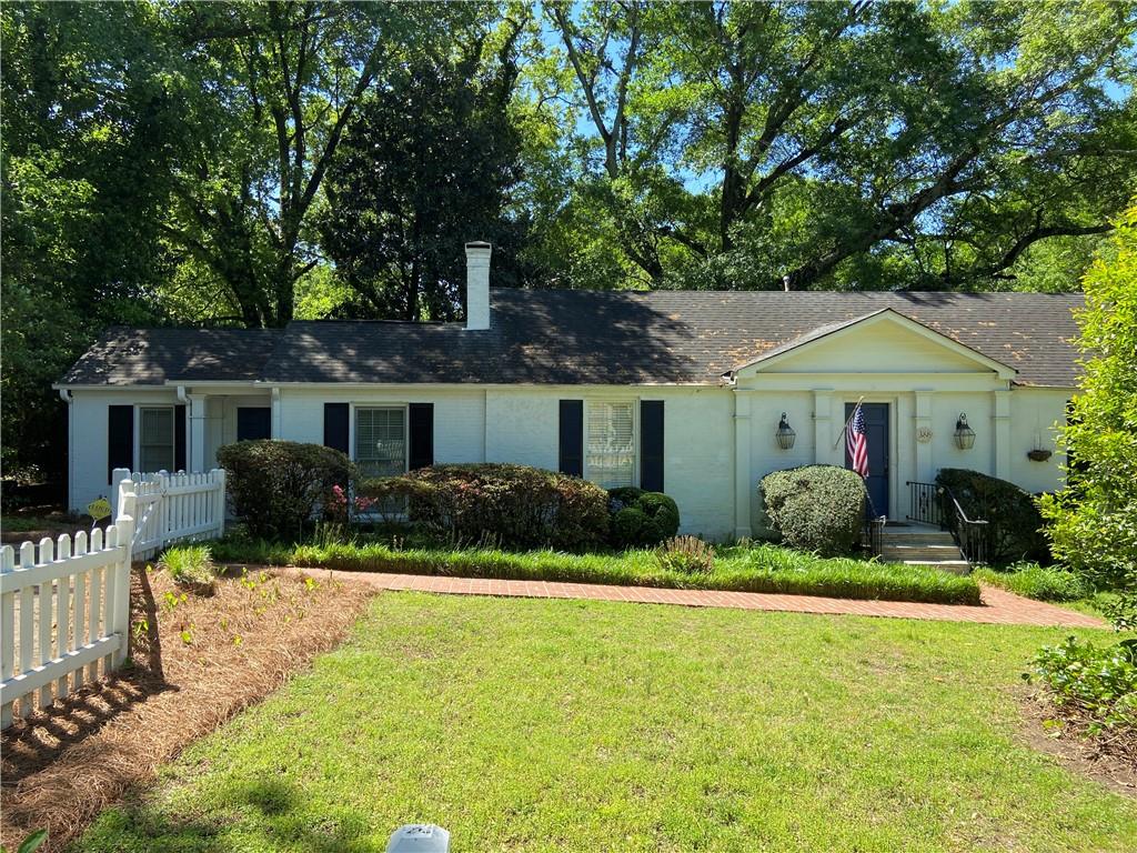 This 3 bed/3 full bath ranch style 1940's house is full of unique charm and character from the original hardwood floors to the beautiful formal dining chandelier! There are two primary bedrooms, on opposite sides of the house, both with an en suite. There is an additional full bathroom in the hall opposite the third bedroom. Eat in kitchen has granite countertops and new stainless steel appliances. There are double french doors, large windows, and sliders throughout the back side of the house, and plantation shutters on the windows in the front. All those doors provide sweet views allowing the outdoors in, and lead to a spacious deck (with perfectly placed wheel chair ramp) and great backyard impeccable for entertaining! Front and backyard fully fenced on Collier Rd among some of the most charming houses in Atlanta. Enjoy in town living in this walkable area complete with sidewalks! Get to I-75 by car in 3 minutes!
