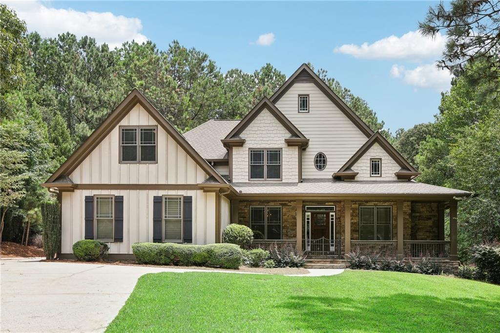 MAJOR PRICE ADJUSTMENT! MULTI-FAMILY DREAM HOME NEAR LAKE LANIER! TOTALLY PRIVATE FENCED IN YARD WITH ROOM FOR A POOL! HARDWOOD FLOORS JUST RE SURFACED, NEW CARPET, DOUBLE SIDED FIREPLACE, ROOM FOR CARS, BOATS, RECREATIONAL VEHICLES AND MORE! 3 car garage craftsman style home nestled on over 1 private acre is a dream come true! No HOA and close to everything Lake Lanier has to offer. Only 1 mile to six mile creek park and boat launch, 4 miles to Port Royale Marina and Pelican Pete's where you can rent any type of water craft and live your best lake life! You will LOVE the dramatic two story family room with double sided fireplace. Hardwood floors throughout main level and all new carpet in bedrooms. The owners suite is conveniently located on main level with sitting area and spa like bathroom and amazing closet space! Main level also includes custom plantation shutters, fireside keeping room with breakfast area and built ins. Super spacious main level laundry room with deep sink even has additional storage. Kitchen door opens to covered deck overlooking resort style patio with fire pit. The custom built lower level is INCREDIBLE! It includes a secondary kitchen,  theater room, 5th bedroom, exercise/craft room, and with full bathroom and lots of sunlight. The second story includes a custom designed teen suite and 2 additional bedrooms with full bathroom. Backyard is fenced in and would be perfect for a pool! Located in the desirable East Forsyth High School district and close to all major shopping. This is a growing area where home prices are on the rise. Don't miss this incredible opportunity!