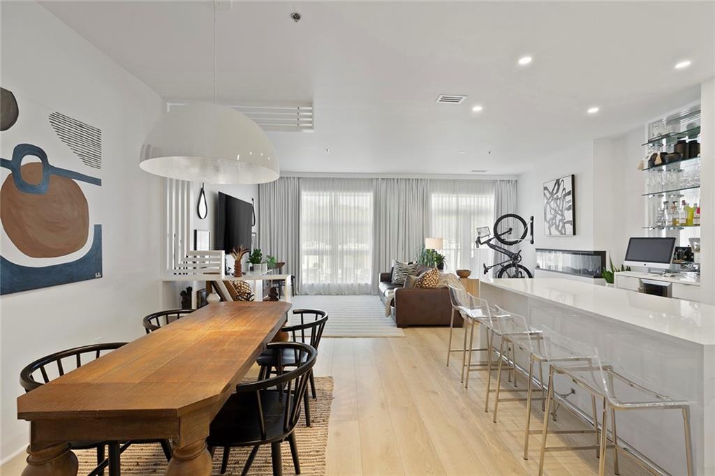 ASK ABOUT OUR 4.99% INTEREST RATE OPTION! Stunning fully renovated one bedroom condo just steps from Piedmont Park! This is not your average renovation; high end finishes throughout that are sure to impress. Chef's kitchen opens nicely to the living room with a spacious island, induction range, smart refrigerator and waterfall quarts countertops. Ample cabinet and counter space plus a pantry. The expansive living room is great for entertaining. Abundant natural light throughout. Loft bedroom has an ensuite bathroom with glass shower and custom closet. Additional custom closet space in the the hallway with a laundry closet. Separate half bathroom for guests. Don't miss the wonderful balcony with great views. Two deeded parking spots. You can't beat this location! The convenience of everything that midtown has to offer with the privacy and tranquility of The Lofts at Belvedere community. Community includes swimming pool, fenced-in dog park, private park, and gated/assigned parking. Furniture is negotiable.