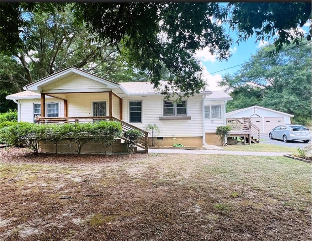 This charming home is waiting for your family to make it your own. Home is in a great location convenient to shopping, restaurants, and downtown Rome yet it has that desirable country living feel. Rocking chair, covered front porch plus a side porch for your grill and outdoor enjoyment. Inside you'll find spacious rooms, updated fixtures and open concept living space. Kitchen has island, dishwasher, and electric range. Master bedroom has his-n-hers closets and bathroom has double vanities. Large 2 car garage has workshop with water and electricity. Pasture land and some fencing is ideal for small farm animals. There are several storage buildings. Don't miss seeing this home.