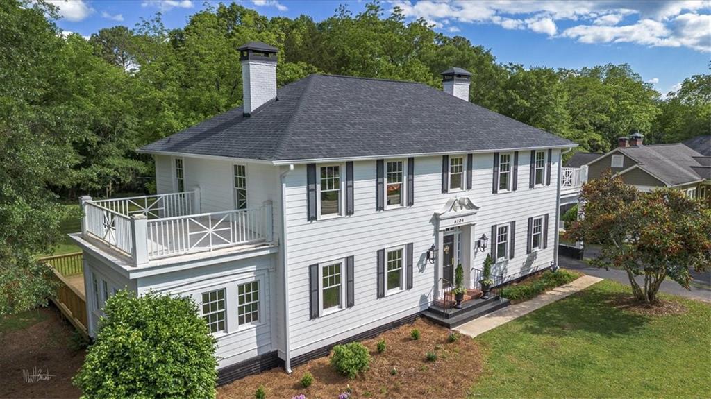 The Manor on Floyd Street - Where timeless charm meets thoughtful restoration. Step into the storybook beauty of this fully restored 1930s Colonial-style manor, where original craftsmanship has been lovingly brought back to life. From the moment you enter, you're greeted by gleaming original hardwoods and stunning heart pine tongue and groove walls and ceilings wood milled from the original owner's very own lumber mill. This one-of-a-kind detail sets the tone for a home filled with warmth, history, and heart. While the character remains untouched, modern upgrades bring peace of mind: hardiplank siding, brand-new energy-efficient windows throughout, fully insulated including spray foam and an encapsulated crawlspace, all-new electrical, a brand new HVAC system, and a tankless hot water heater for endless efficiency. The updated kitchen is a chef's dream, featuring a six-burner gas range with an electric oven and stylish finishes that blend seamlessly with the home's vintage soul. With 5 spacious bedrooms and 4 full baths, there's room for everyone. A guest suite with a full bath is located on the main level, while upstairs, the primary suite offers a peaceful retreat with an oversized custom tile shower, double vanity, and private water closet. Three additional bedrooms and two more full baths complete the upper level. Nestled on over an acre along Covington's iconic and historic Floyd Street, this one-of-a-kind home offers the rare blend of downtown charm and spacious grounds. The Manor on Floyd Street isn't just a house - it's a treasured piece of Covington's history, a legacy, lovingly brought back to life and ready for its next chapter. Come feel the warmth, the history, and the heart of this truly special home.
