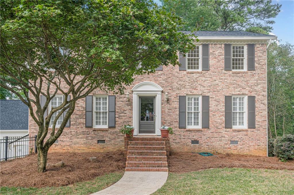 One of the most desirable features of this property is the private in-law suite above the garage, complete with its own kitchenette—perfect for guests, extended family, or even potential rental income. No HOA and a brand new roof add even more value to this exceptional home. Step into timeless elegance with this stately Colonial-style residence, full of charm, character, and thoughtful details throughout. Boasting 4 spacious bedrooms and 4.5 well-appointed baths, this brick-front beauty is nestled on a well-manicured lot that radiates curb appeal. Inside, you're welcomed by rich architectural touches, including French doors that open into a sophisticated formal living room or private study, ideal for working from home or quiet reflection. The inviting great room is a true gathering space, featuring a classic brick fireplace and built-in wet bar for effortless entertaining. The heart of the home is the bright white kitchen, beautifully outfitted with stainless steel appliances, gleaming granite countertops, a center island with breakfast bar, a charming bayed breakfast nook, and abundant storage. The formal dining room offers a refined space for hosting guests and holiday dinners. Upstairs, the oversized owner's retreat is a peaceful sanctuary with a private bath featuring double vanities and a tub and shower combination. Secondary bedrooms are generously sized, and the additional bath is finished with granite countertops and stylish touches. The fully finished basement offers incredible versatility, with ample flex space for a media room, gym, playroom, or all of the above. Step outside and unwind on the covered patio or entertain with ease on the covered rear deck overlooking the fenced backyard, ideal for pets, play, or quiet evenings under the stars. All of this is conveniently located just a short drive to major interstates, offering the perfect balance of comfort, convenience, and lifestyle.