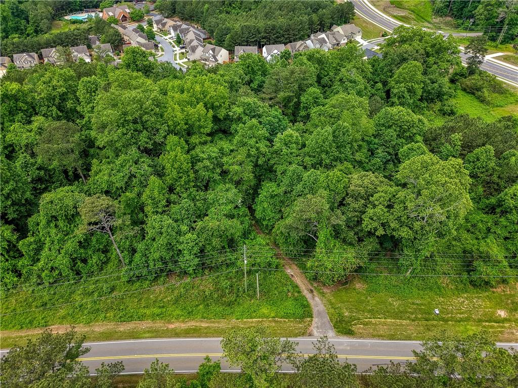 Investors and Developers...Prime Development Opportunity Near Fate Conn Road & Heard Road...Priced below recent appraisal! Land lies within the City of Canton's Future Development Corridor as suburban development as notated within their 2045 Comprehensive Plan (see in documents section).
Positioned just off the new major roundabout at Fate Conn Road and Heard Road, this exceptional tract of land lies in a rapidly developing corridor—making it a strategic investment opportunity. The property is surrounded by established and desirable communities such as Riverstone, Great Sky, and The Bluffs, and is located less than one mile from the scenic Hickory Log Creek Reservoir boat launch. With immediate access to I-575, retail, dining, and daily conveniences, this location combines accessibility with long-term growth potential.
The land is equipped with county water and a septic system, offering flexibility for a variety of uses—residential, commercial, or mixed-use development. Current county guidelines should allow for the development of up to five lots with septic, with potential for increased density contingent on extending sewer service from nearby infrastructure as property is adjacent to city along it's eastern boundary. This makes the property ideal for a boutique subdivision, or a light industrial/storage facility or potential for high density development within that mix of options with county or city approval.
Important Note: The existing structure on the property is not habitable and should be considered a tear-down. Entry into the home is strictly prohibited without prior written authorization from the listing agent.