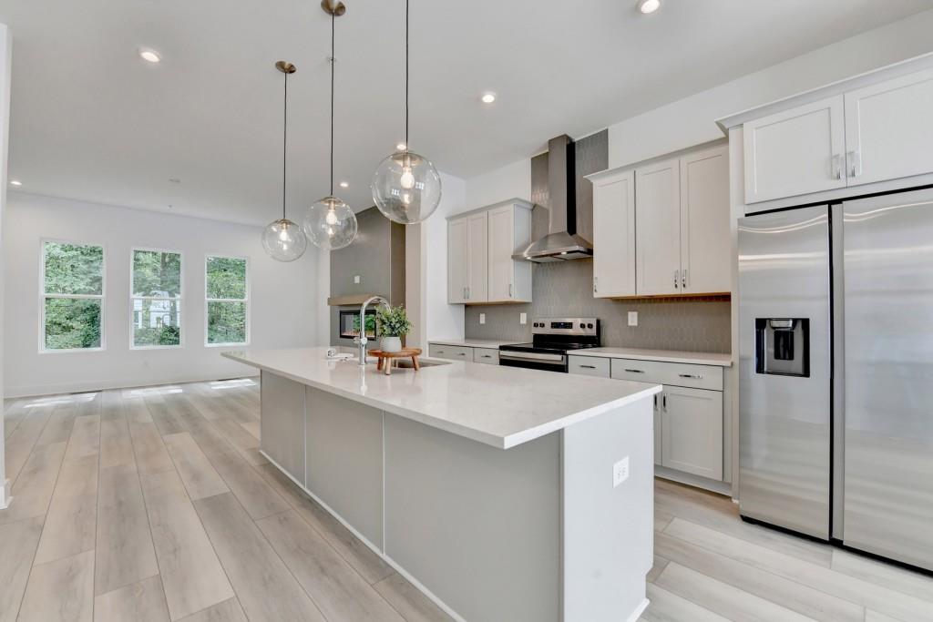 Awesome opportunity to be the very first tenant in this new construction Toll Brothers luxury townhome located in the middle of everything Midtown and Buckhead have to offer! Located in a quiet residential neighborhood, 568 West is right off of Northside Drive and close on/off to 75/85. Minutes to Geogia Tech (Gameday!!),The Works, Westside Provisions, Atlantic Station, breweries, art galleries, and the future BELTLINE WEST expansion. Enter the front door and there is the two car garage with EV charging capability, a lower level bedroom/home office with private full bath featuring a tiled, frameless glass shower, vanity with quartz countertop. Head to the main level and find the beautifully appointed kitchen, with lots of painted cabinetry, quartz countertops, center island, pendant lighting, plus LED recessed lighting. Stainless appliances include electric cooking with vent hood vented to outside, under-counter microwave drawer, refrigerator with water/ice dispensing, dishwasher, walk-in pantry, dining room, family room with linear fireplace, and half bath. The second floor features laundry room with NEW washer/dryer, two bedrooms, including the primary bedroom. Each of these bedrooms has an ensuite bathroom. The primary bath features double vanity, quartz countertops, undermounted sinks, tiled frameless glass shower, and two separate walk-in closets. The other bedroom on this level has a private tiled bathroom with tub, vanity with quartz countertop, undermounted sink and walk-in closet. Step up to the upper level and discover an open loft area for lounging, bedroom with walk-in closet, full bath with vanity, quartz countertop, undermounted sink, tiled bath with tub. Walk out to the fabulous rooftop terrace! Flooring throughout is LVP (no carpet!) and all of the gorgeous upgraded designer extras lend a custom luxury feel to this spectacular townhome! Guest parking in designated guest/visitor parking spots, or street parking.