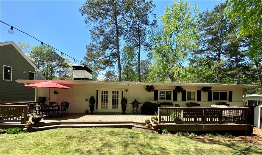 A charming 3 bedroom 2 bathroom ranch in Ashford Park, Brookhaven, within walking distance from Ashford Park Elementary and 3.5 acre Ashford Park with tennis courts.  This beautiful home with hardwoods throughout is updated with a new stone kitchen floor.  Enjoy a spacious open kitchen into dining and living areas with a fireplace and vaulted ceilings. Fenced in backyard includes a spacious deck for outdoor entertaining under cafe string lights. Please see photos and available to move in immediately.