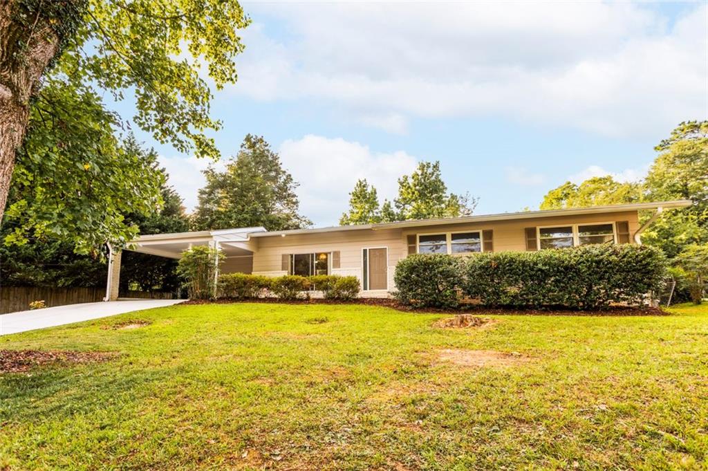 Nestled in the highly sought-after Lavista Woods neighborhood of Tucker, GA, this charming mid-century modern home offers the perfect blend of serene living and urban convenience. Surrounded by beautifully updated homes, manicured lawns, and tree-lined streets, Lavista Woods exudes a strong sense of community and tranquility, yet it's just minutes from Northlake Mall, diverse dining along Lavista Road, and the recreational haven of Henderson Park with its trails and sports fields. With easy access to I-285, Atlanta's vibrant downtown is within reach, making this location ideal for families and professionals alike. The home itself boasts new insulated windows and stunning white oak hardwood floors that flow throughout its thoughtfully designed 3-bedroom, 2-bathroom layout. Additional space includes a full dining room, separate living area, mud room and breakfast area. A private level backyard provides a serene space for outdoor relaxation or entertaining, while a covered carport offers convenient and protected parking. The unfinished basement adds versatile space, perfect for storage, a workshop, or a creative retreat, allowing you to customize it to your needs. This well maintained residence is a canvas awaiting its new owner's personal touches to transform it into a true haven. Don't miss the opportunity to own a piece of Lavista Woods' charm, where community, modern comfort, and natural beauty converge. Come see this beautiful home in a neighborhood where properties rarely come available on market today!