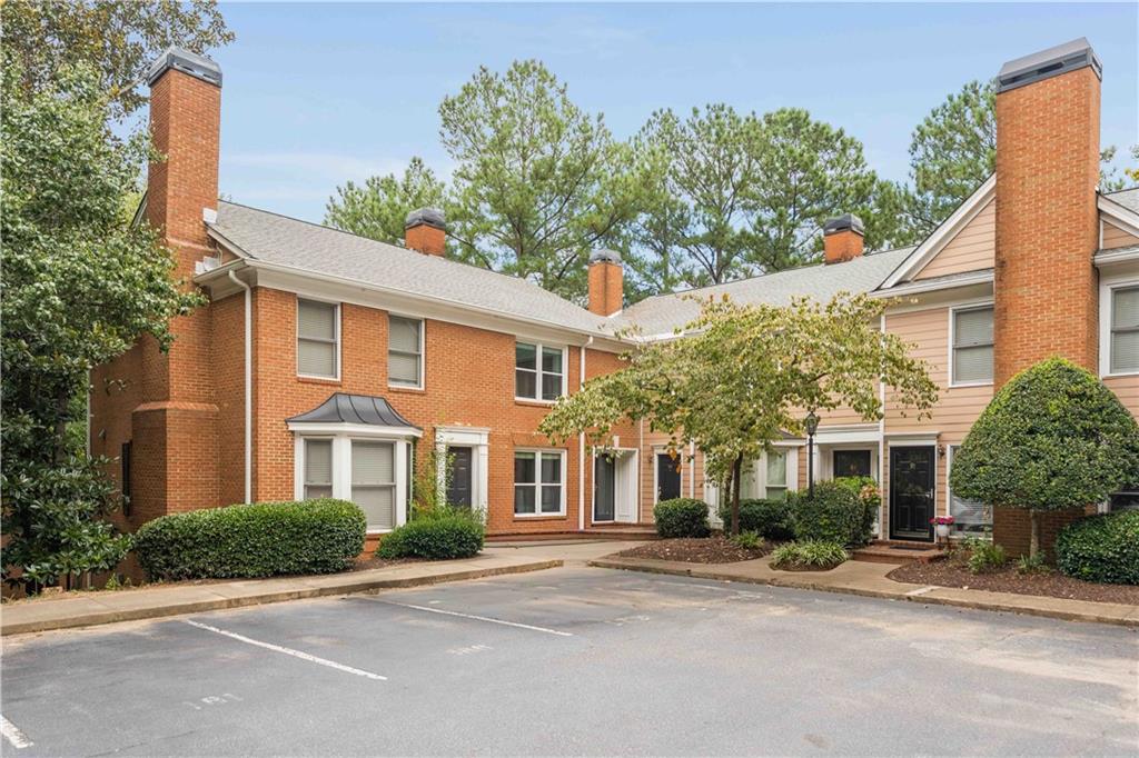 Say hello to this beautifully renovated two-story condo in the esteemed City of Sandy Springs! Tucked away in the coveted gated community of The Accolades, this stylish and low-maintenance gem lives like a townhome without all the upkeep! A timeless brick exterior gives a warm welcome, while the sun-soaked interior showcases a neutral color palette and hardwood floors throughout the main level. Inside, you’ll find thoughtful updates, including newer windows (2020), a 3-year-old HVAC, 5-year-old water heater and freshly painted kitchen cabinets that add a modern, yet classic touch. Cozy up in the fireside family room for movie nights or host friends with ease in the generously sized space. A bright, airy dining room is open to the kitchen and flows effortlessly into the charming solarium-style breakfast nook, complete with floor-to-ceiling windows. It’s the perfect spot for morning coffee or weekend brunch! Functional as it is attractive, the well-equipped kitchen boasts white cabinetry, granite counters, stainless steel appliances, abundant prep and storage space, and a breakfast bar that comfortably seats two. Unwind on the back deck conveniently located off the breakfast area. A chic powder room highlighted by a shiplap accent wall and updated vanity completes the main level. Retreat upstairs to two sizable bedrooms, each with its own en-suite bathroom, making it ideal for guest privacy or a considerable roommate floor plan. Flaunting three closets (including one with built-in shelving!), the large primary bedroom provides significant storage and a refreshed bathroom with new vanity! Premier location for commuting in or outside the perimeter. Close to GA 400 and I-285. Moments to shopping, dining, Publix, Sandy Springs City Center, Steel Canyon Golf Course, Perimeter Mall, Northside Hospital and Morgan Falls Overlook Park with stunning views overlooking the Chattahoochee River, hiking trails, pavilions, stand up paddle boarding, canoeing and kayaking rentals, playground, dog park and access to the Springway hardscape trail! Community amenities include a pool, tennis courts, clubhouse and pet stations. A beauty that truly has it all!