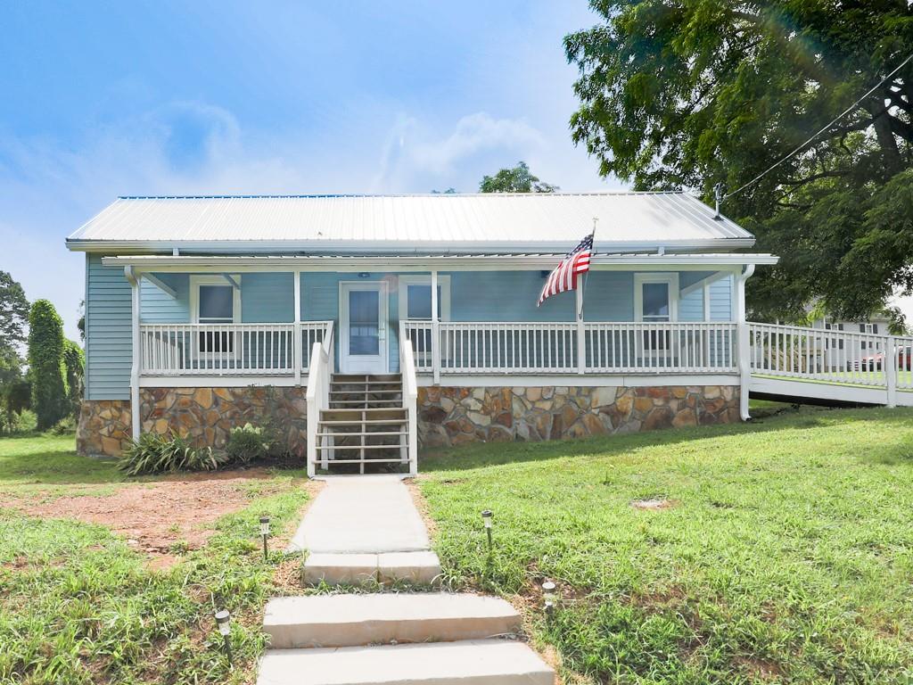 For the LOVE of OLD houses!
3/2, Country HOME with usable half acre lot situated in the heart of cozy, quaint community of Nelson, GA. Has just recently been brought up to code including all new wiring, plumbing, septic. Additionally, home has brand new metal roof, gutters, hot water heater, total electric HVAC, dual system septic. Brand new appliances, lighting, granite, bathrooms, fresh paint, LVP throughout. Gas logs fireplace. Additional highlights are the property has a new survey, Dual septic's, new insulation, new blinds and all the windows are vinyl! A perfect blend of old school and new, home has much of the original doors and trim, lovely eat in kitchen with large apron farmhouse sink. Nice huge deck on back for entertaining, big front porch overlooking neighborhood, with long range seasonal mountain views. Property includes storage building. Up-and-coming area, lots of young families out walking their children and fur babies to not one but two nearby parks. You will love this area, so convenient to both Jasper and Ball Ground, Canton and Highway 515. Great starter home, money generating rental home or retirement home.