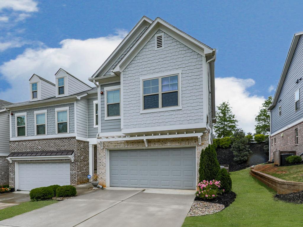 Welcome to 130 Maple Creek Way, Woodstock, GA 30188—a rare END unit townhome that perfectly blends sophistication and comfort. Upon entering, you’ll be greeted by an elegant designer color scheme and meticulous attention to detail, creating a warm and inviting ambiance that feels like home. This well-cared-for END unit showcases a calming color palette and features a modern island kitchen equipped with a walk-in pantry and quartz countertops, which seamlessly connects to a spacious great room, ideal for entertaining guests. Furnishing are available for sale, making this a seamless turn-key opportunity. The main level is adorned with upgraded luxury vinyl flooring, enhancing both style and durability. The master suite serves as a private retreat, complete with a comfortable sitting area and a beautifully designed master bath. Generously sized secondary bedrooms offer plenty of room for family or visitors. The exceptional backyard is a stunning oasis of its own, featuring extensive landscaping that showcases nature’s beauty. Enjoy plenty of parking with a 2-car garage and a long driveway that accommodates additional vehicles. Located mere minutes from downtown Woodstock, with easy access to highways and proximity to shopping, recreation, and dining, this townhome masterfully combines convenience and charm, making it the perfect place to call home.