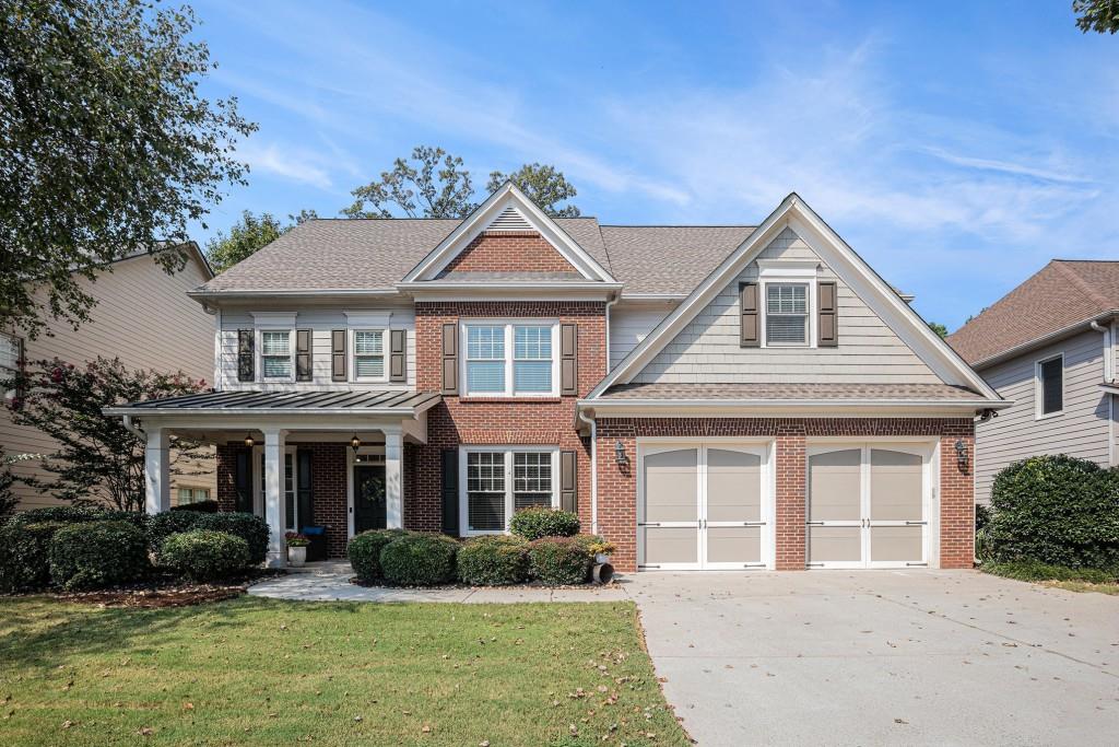 Stunning Traditional South Forsyth Home in the highly sought-after Liberty Community! Residents enjoy top-tier amenities including a Clubhouse, Fitness Center, Olympic-Sized Pool, Playground, Tennis Courts, and Sidewalks. Step inside to gleaming Hardwood Floors, elegant Crown Molding, and abundant Natural Light pouring throughout. To the left, a dedicated Home Office Study with custom built-ins and storage provides a functional workspace. To the right, a Formal Dining Room with wainscoting and a large window offers a beautiful setting for gatherings. At the heart of the home, the Fireside Family Room features built-ins and a two-story wall of windows an inviting space for entertaining. The open Chefs Kitchen showcases stained cabinets, a Large Granite Island perfect for casual meals, Stainless Steel Appliances including Double Ovens, a Walk-In Pantry, and additional counter space with open shelving ideal for a beverage station. A cozy Breakfast Nook surrounded by windows provides a bright spot for morning coffee, with a door that leads to the private Backyard. A Full Bathroom and Bedroom on the main floor offer flexibility for guests or a secondary Home Office. Even your furry friends have a special spot under the stairs with a dedicated dog door, spot for a bed, and space for water and food. Upstairs, the Primary Retreat is a spacious haven with room for a sitting area, tray ceiling, and an Ensuite Bathroom featuring a Double Vanity, large Soaking Tub, separate shower, and a generous Walk-In Closet. Three Additional Ensuite Bedrooms, each with large Walk-In Closets, provide comfort and privacy for family or guests. An Unfinished Attic with permanent stairs awaits your personal touch perfect for a Media Room, Playroom, Gym, or extra storage. The Fully Fenced Backyard is ideal for game days and outdoor living, featuring a covered back patio, grassy area, and a tiered section perfect for a playground or yard games. This prime location is just minutes from Sawnee Mountain Preserve, Fowler Park, GA-400, The Collection at Forsyth, Market Place Blvd, Northside Hospital, and top-rated Forsyth County Schools. Enjoy boutique shopping, dining, entertainment, scenic trails, and sunny afternoons on Lake Lanier all just steps from your door. Don't miss this rare opportunity to combine a vibrant sense of community with convenience and style!