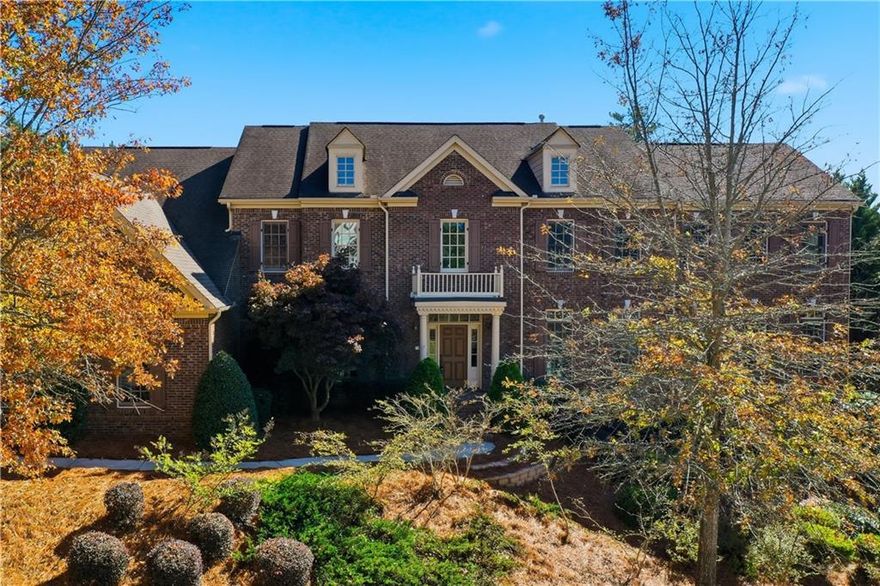 Nestled within one of Downtown Woodstock’s most coveted swim and tennis communities—just a half-mile from the heart of town—this stunning residence offers refined luxury, exceptional craftsmanship, and a lifestyle of ease and sophistication. 

Boasting 6 spacious bedrooms, 6 full baths, and 2 half baths, this grand home is designed for both elegant entertaining and comfortable everyday living. The open-concept floorplan flows effortlessly, anchored by a breathtaking 600 sq. ft. Grand Salon, where dual sweeping staircases make a dramatic first impression. 
Throughout the main level, you’ll find newly installed marble, wood, and tile flooring, a refined formal dining room, a sunroom with dual-sided fireplace, and a main-level guest suite with private ensuite. 
At the heart of the home, the chef’s kitchen is a culinary masterpiece, featuring a 12-foot granite island, (2) refrigerator/freezer, GE Monogram 5-burner gas range with griddle, dual microwaves, and custom cabinetry with pull-out shelving. A sunlit keeping room and walk-in pantry complete the space, perfect for hosting or relaxing with family. 
The Grand Owner’s Suite is a true retreat, offering a private sitting room with fireplace, luxurious spa-inspired bath with dual water closets, whirlpool tub, oversized walk-in shower, dual vanities, and an expansive dressing room. Each of the three additional upstairs bedrooms features a private bath; two are designed as junior suites with separate sitting or study rooms and additional closet space. 
The fully finished terrace level (completed in 2021) is an entertainer’s dream—or a luxurious in-law suite—complete with two living areas, a media room, dining space, full kitchen, guest suite with custom built-ins, full bath with walk-in shower, a half bath, private gym, and ample storage. 
Step outside to your resort-style backyard oasis, showcasing a PebbleTec® saltwater pool and spa with dual waterfalls, self-cleaning system, and 1,000+ sq. ft. Travertine patio with extensive outdoor lighting in both front and backyard. Enjoy the stone fire pit, lush landscaping, and serene outdoor living—all while listening to live music from downtown’s concert series right from your backyard. 
Set on nearly half an acre, this impeccably maintained home offers walkable or golf cart access to all that Downtown Woodstock has to offer—including renowned dining, boutique shopping, Friday Night Live events, summer concerts, spas, and vibrant community gatherings year-round.