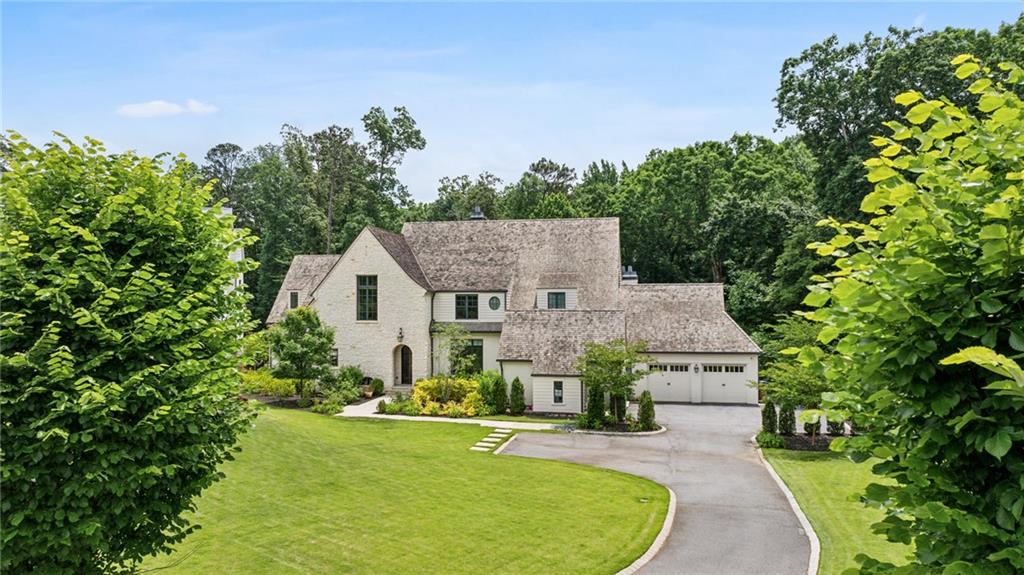 Welcome to this stunning home located on a quiet Buckhead cul-de-sac. With 6 bedrooms, 6 full bathrooms, and 2 guest powder rooms, this residence offers ample space for comfortable living. As you step inside, you'll be greeted by a welcoming entry foyer that sets the tone for the elegance and sophistication found throughout this home. The main level primary suite features a spa-like en-suite and custom walk-in closets. Gleaming hardwood floors add a touch of warmth and charm to the residence, while the epicurean kitchen is a chef's dream, complete with high-end appliance, custom cabinetry and a walk-in pantry. The family room is the heart of the home, featuring a cozy fireplace and a beamed ceiling that adds character and style. It's the perfect spot to relax with loved ones or entertain guests. The finished terrace level provides additional living space with a full in-law suite and 2nd kitchen. Step outside and discover a true oasis. The saltwater pool is perfect for those hot summer days, while the spacious backyard offers plenty of room for outdoor activities and gatherings. You'll also find two covered patios with fireplaces, creating the ideal setting for al fresco dining or cozy evenings spent by the fire.