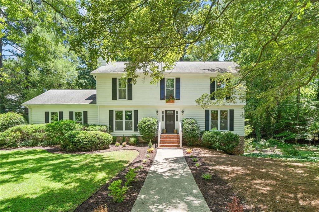 Welcome to this beautifully updated 5-bedroom, 3.5-bath home in the highly sought-after Walton High School district, tucked away on a quiet cul-de-sac in an established East Cobb neighborhood. Set on a peaceful, wooded lot with no HOA, you’ll immediately appreciate the privacy and beautiful nature surroundings. This home is perfect for buyers wanting to live in the desirable school zone of Walton High which has been ranked among Georgia’s Top 10 high schools for over 20 years by U.S. News & World Report, and nearby Dickerson Middle was named the state’s #1 middle school in 2024.
Thoughtfully renovated while retaining classic East Cobb charm, the interior is spacious and filled with natural light. The inviting living room offers a cozy retreat with a painted brick fireplace, and the heart of the home—a modern kitchen with new tile flooring and appliances—flows seamlessly to the main living areas. Upstairs, the oversized owner’s suite boasts its own private deck for morning coffee or evening relaxation.
The fully finished daylight basement features a separate entrance, updated bath, and new flooring—ideal for a guest suite, home office, or income-producing rental. Outside, two additional private decks overlook a serene backyard oasis, and the generous side yard is ready for entertaining family and friends at the large firepit or with enough space if you wanted to add a play area. The huge front lawn offers tons of curb appeal with a freshly landscaped yard and walkway leading to the new front door. Friendly neighbors and optional membership at Indian Hills Country Club add to the community appeal.
Just 12 minutes from Truist Park and within easy reach of Sandy Springs, Buckhead, Roswell, and more, this East Cobb gem offers the perfect blend of privacy, top-ranked schools, quality construction, and prime location. Don’t miss your chance to call 411 Woodstone West Drive home!