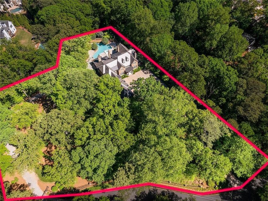 Spectacular private gated estate on 2.36 fenced acres, on a culdesac street in Buckhead. Perfect for walking with no cut through traffic. The residence is perfectly sited up a long driveway and overlooks the combined, separately deeded parcels.  Imagine your forever home surrounded by beautifully professionally landscaped gardens and walking paths.  Plenty of room to add a guest house if desired.  Double gates and completely fenced and private. Rare walk out pool and entertaining patios from the living, family room and kitchen.  Outdoor entertaining spaces with covered outdoor kitchen and fireplace. Walk on the trails all around the property.  Separate well for watering the landscape.  Separate monitored security for the neighborhood.  Exceptional builder, Tony Reaves, Intown Builders and Harrison Design architects created this masterpiece of brick, stone, copper gutters and a slate roof. The custom designed kitchen is open to the family room with brick barrel ceiling and fireplace and all opens to the pool.  The chef's kitchen has double Sub Zero refrigeration, drink drawers, icemaker and Wolf appliances, Calacatta gold marble countertops and custom Karpaty cabinetry. Plenty of storage capacity plus a walk in pantry. Ceilings throughout are 10 - 12 feet on all levels. Wide plank reclaimed hardwoods, solid doors and windows, six masonry fireplaces and stone floors on the terrace level showcase the quality of this spectacular home. This property is fully loaded with Control 4 technology, elevator, whole house generator, Control 4 lighting, security and music throughout.  Two primary bedroom suites, one on the main and one upstairs. There are four more on-suite bedrooms upstairs and a TV, study or game room.
Fully finished terrace level with bar, home theater, game room, gym, billiards and ping pong. Plenty of room for a golf simulator or larger gym.  Oversized garages and porte-cochere with loads of extra parking at the main house and on the side lot.  Enjoy a movie in the theater that seats 10+, spectacular redone double private pool, spa and waterslide. Major renovations and quality upgrades throughout. If you have been looking for the perfect private home in superb quality and condition, transitional and fresh, private and move in ready, this is it! Located in the high desirable 30327 and close to everything in Buckhead, Sandy Springs and Chastain Park.