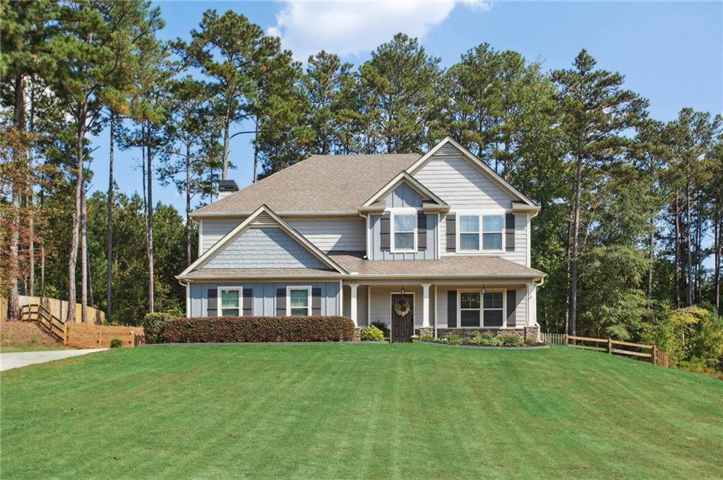 Stunningly updated and move-in ready! This nearly new home features engineered hardwoods throughout. Enjoy hosting family and friends in your designer kitchen, complete with top-of-the-line appliances, double pantries featuring custom shelving, and a spacious entertainer’s island. Relax on the screened porch with stone fireplace or enjoy the covered outdoor patio, both with TVs—perfect for game day! Inside, the fireside family room and elegant dining room with coffered ceilings set the stage for gatherings. The luxurious primary suite offers dual closets, soaking tub, and tiled shower. Secondary bedrooms boast tall ceilings and generous storage. Additional highlights include a temperature-controlled garage with mini-split system, perfect for a workshop, craft space, or storage. Enjoy a large flat fenced yard ideal for children and pets, complete with a storage shed. Key features to note: Spray foam insulation, New HVAC system (2022), New hot water heater, fresh paint throughout, upgraded designer lighting, custom closets, and more. Tucked on a quiet street with extra HOA parking and a covered cabana perfect for hosting parties right across the street. Easy access to I-20, top schools, and all the dining, shopping, and parks of Carrollton and Villa Rica. This home truly has it all!