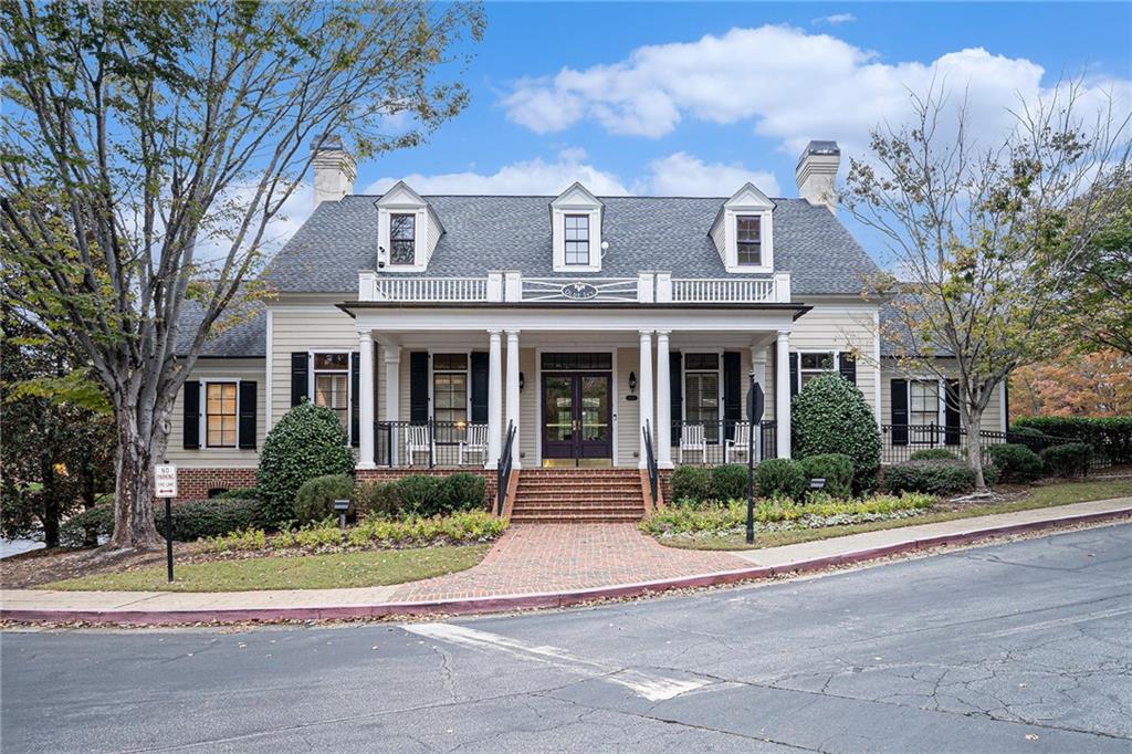 Do not miss this gorgeous condo that’s very well maintained with open floor plan, hardwood flooring and a private, peaceful, wooded view. This building has no steps to climb to the front door, plus there is an elevator down to the parking garage making this place truly "Living with no stairs". Spacious kitchen with all appliances replaced during their ownership. Kitchen features stainless steel appliances, granite countertops, tile backsplash, stained cabinetry, recessed lighting, breakfast bar, and built in Microwave. Open concept formal dining room. Large great room with built-in shelving, decorative columns, and marble fireplace with gas logs. Large master bedroom with built-in shelving, crown molding, access to the private balcony and spacious walk-in closet. Master bathroom features tiled flooring, double vanity, glass framed tile shower and whirlpool tub. Spacious secondary bedroom with great closet space. Bonus room works well for an office or separate TV room. This unit comes with an assigned parking spot along with a storage closet and Tesla charger which is universal allowing other EV cars to be charged. The washer, dryer and refrigerator will be staying.  The rental cap for this complex is 25% and it's currently at less than 14%. Great clubhouse community activities include a Book club, football game parties and holiday parties. This is a very popular gated community with great amenities, including a large swimming pool, fitness center, walking trails and in a great location within minutes of 285, I-75, Atlanta and airport.