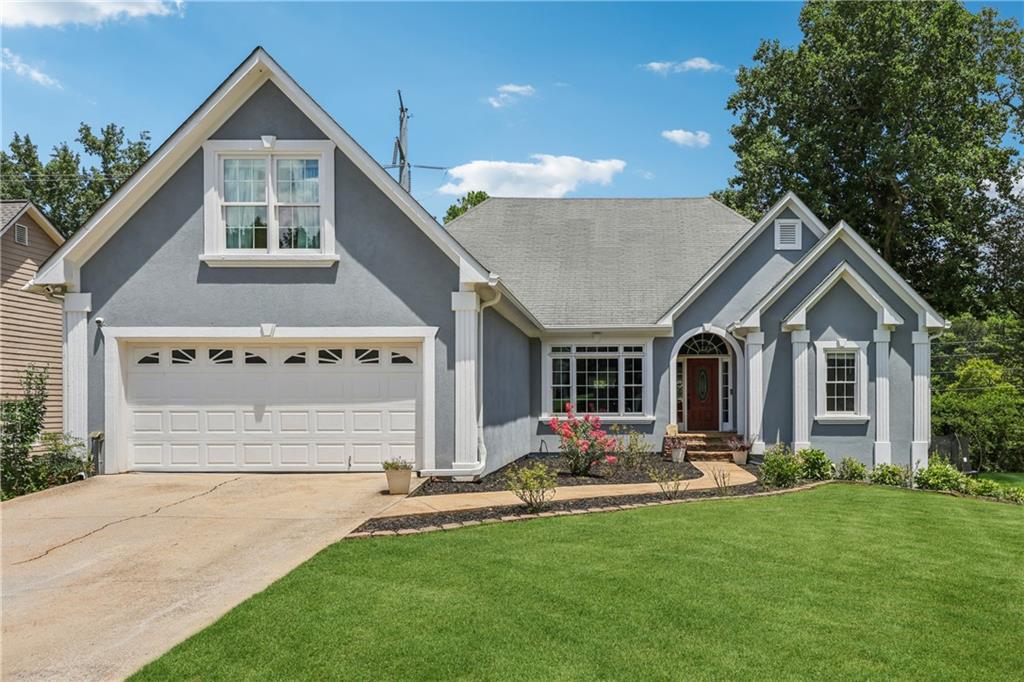 MUST SEE! With an assumable VA loan at 2.25%, this one checks all the boxes—space, charm, and an unbeatable location in the Collins Hill School District. From the moment you walk in, you’ll feel right at home. The main level features a spacious primary suite with a beautifully renovated bathroom that feels like your own private spa. You’ll also find two additional bedrooms and a full bath—perfect for guests, kids, or a home office. The living room boasts soaring ceilings and a cozy double-sided brick fireplace shared with the sunroom—perfect for enjoying peaceful Georgia evenings year-round. The updated kitchen is a true highlight, featuring a gas cooktop, granite countertops, and a formal dining area ideal for hosting or quiet dinners at home. Upstairs, there’s a private bedroom with its own full bath—great for guests, in-laws, or a teen retreat. Need even more space? The finished basement is ideal for guests or in-laws, featuring a private bedroom, full bath, custom bar, and a cozy theater room—plus a separate entrance that leads directly to the screened-in porch, offering comfort and privacy! Outside, the fenced backyard offers privacy, lush landscaping, and a shed for tools or outdoor gear. Durable LVP flooring throughout adds a modern touch and easy maintenance. Recent upgrades include new siding, gutters, and most windows—completed in March 2023—as well as an EV charging station compatible with Tesla, offering both modern convenience and peace of mind! Come see it for yourself and fall in love!