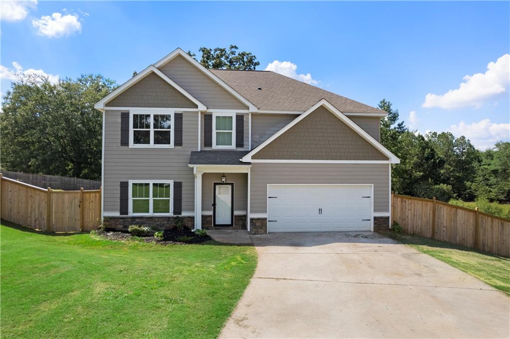 Welcome to a beautiful Craftsman-style home in Carrollton, GA. Built in 2018, this spacious residence offers 4 bedrooms, 3 full bathrooms, and approximately 2,735 sq ft of thoughtfully designed living space. Step inside to find an inviting open-concept floor plan with abundant natural light. A main-level bedroom and a full bath for flexible living arrangements.
Upstairs offers a spacious owner’s suite featuring a sitting area and private bath with custom tile and upgraded shower. A versatile media room/bonus space at the top of stairs perfect for work, recreation, or relaxation separating the owner's suite and the additional 2 bedrooms and bathroom.
The kitchen is a standout, with granite countertops, stainless steel appliances, a central island, and a breakfast area. Additional comforts include a fireplace, LVP flooring, and energy-efficient features such as double-pane windows and insulated ceilings.
Outdoors, enjoy a covered patio overlooking the community pond and a generous 0.66-acre lot that provides both space and privacy including a new Privacy fence around the property.
This home combines modern design with practical features in a desirable Carrollton location. Schedule your private tour today!