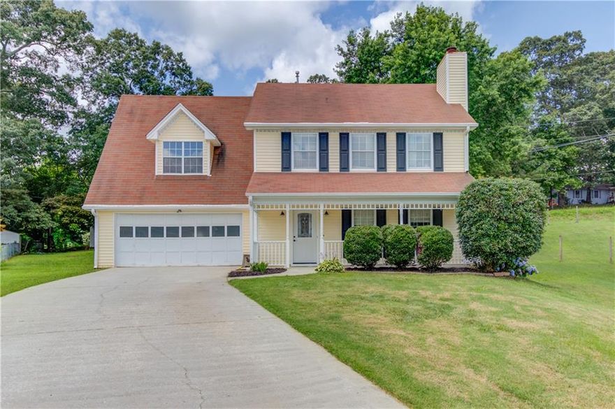 Welcome home to this beautifully updated gem in a prime Sugar Hill location just minutes from top-rated schools, shopping, dining, and major highways! Nestled on a quiet cul-de-sac in a no-HOA community, this spacious 4-bedroom home offers stylish updates and a fantastic layout. The large family room flows seamlessly into the dining area, creating an inviting space for everyday living and entertaining. Enjoy cooking in the refreshed kitchen featuring stainless steel appliances, granite countertops, eat-in area, an updated pantry area and brand-new flooring on the main level. Upstairs, you'll find four generously sized bedrooms and updated bathrooms that add a modern touch. Relax on the cozy front porch or take advantage of the huge backyard, partially fenced and perfect for pets, play, or a future garden oasis. Additional highlights include new carpet upstairs, a large wide driveway with ample parking, and a wonderful sense of privacy. A rare find in Sugar Hill-don't miss it!