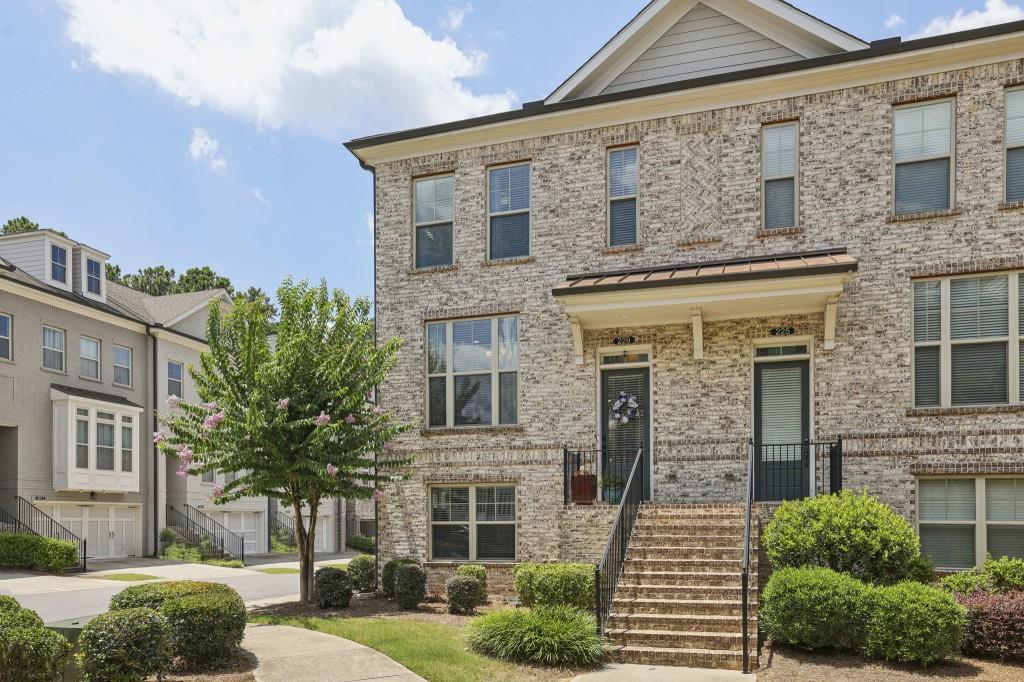 Rare End-Unit Gem in the Top-Ranked Northview High School District! Ideally located in the heart of Johns Creek recently named the #1 Place to Live in the U.S. this beautifully appointed townhome sits within a sought-after Gated Community offering unmatched convenience and lifestyle perks. Step inside to discover Soaring Ceilings, Gleaming Hardwood Floors, and Elegant Crown Molding throughout the main level. The Open-Concept Layout features a spacious Fireside Family Room with a striking Stone Fireplace and Wood-Beamed Mantel, plus a bright Flex Space perfect for a Home Office or Reading Nook. A Private Back Deck provides an ideal for morning coffee or evening wine. The Chef's Kitchen is a true showstopper, complete with Granite Countertops, Classic White Cabinetry, Subway Tile Backsplash, Stainless Steel Appliances, and an Oversized Island perfect for entertaining or everyday meals. A dedicated Dining Area connects seamlessly with the kitchen for easy flow and open sightlines. Upstairs, the Oversized Owner's Suite is a serene retreat with a Tray Ceiling, Massive Walk-In Closet, Dual Vanities, Glass-Framed Shower, and a Luxurious Soaking Tub. A spacious Secondary Bedroom with a Private En-Suite Bath provides the perfect setup for guests or family. The Laundry Room is conveniently located upstairs. The Finished Terrace Level adds incredible versatility with a Full Bedroom and Bathroom ideal for guests, a home gym, or a playroom. An Oversized Garage offers excellent storage, and the Back Deck delivers peaceful, private views. Enjoy Resort-Style Amenities including a Swimming Pool, Tennis Courts, Clubhouse, and Playground. The home is walking distance to Cauley Creek Park, a local gem featuring a 5K Paved Trail, activity lawns, and recreation areas for walking, biking, and enjoying the outdoors. Just steps from Publix, coffee shops, and restaurants with a brand-new, Avalon-style shopping and dining district under development nearby this location offers both immediate convenience and exciting future potential. Centrally located with easy access to Suwanee, Duluth, Alpharetta, and Cumming, this home is more than a place to live it's a lifestyle.
