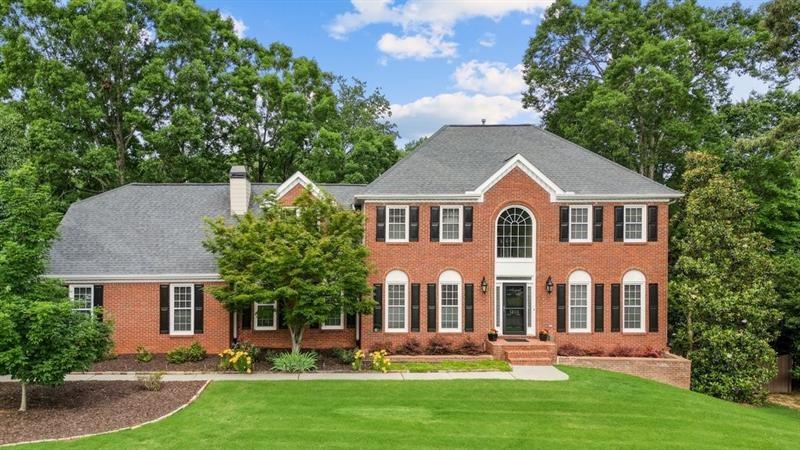 Welcome to this elegant brick-front home situated within an attractive West Cobb swim and tennis/pickleball community. This spacious and well-maintained residence features five bedrooms, four full baths, and a full finished basement. The main level is designed with a light-filled, open-concept layout that seamlessly connects the family room, kitchen, and dining areas—perfect for both everyday living and entertaining. The family room boasts built-in bookshelves and a beautiful stone fireplace with gas logs while the kitchen features granite countertops and stainless steel appliances including a range with double ovens. This area of the home has hardwood floors.
Also on the main floor, you'll find a separate living room, a laundry room, and a guest bedroom with a full bath—ideal for visitors or multigenerational living. Upstairs, the expansive master bedroom suite includes a private sitting room that works well as an office and a massive walk-in closet system comprised of three separate closets! One of these closets is a small room with built-in cabinetry and counter space, offering potential as a craft room or dressing area. Two additional bedrooms and a full bath complete the upper level.
The finished basement offers a large recreation room perfect for movie nights or a game of pool plus a private bedroom and full bath. With hookups already in place for laundry and plumbing in place for a future kitchen/kitchenette, the basement is well-suited for use as an in-law suite. An unfinished room in the basement provides even more storage options.
Outside, the beautifully landscaped yard includes a fenced-in backyard, a storage shed, a deck off the kitchen, and a lower patio with a sitting area. Recent updates enhance peace of mind and comfort, including new shutters, brand new furnace and AC units for the main floor and basement, and newer HVAC units for the upstairs. Interior rooms and the exterior have recently been painted.
This location provides easy access to I-75 and is just minutes away from fantastic nature trails at Kennesaw Mountain. Abundant shopping and dining options along Barrett Parkway and Dallas Highway add to the convenience. This is a great school district with Kennesaw Mountain High School and its magnet program for mathematics, science, and technology. There are also many excellent private school options in this area. Schedule your showing today to experience all that this exceptional home has to offer!