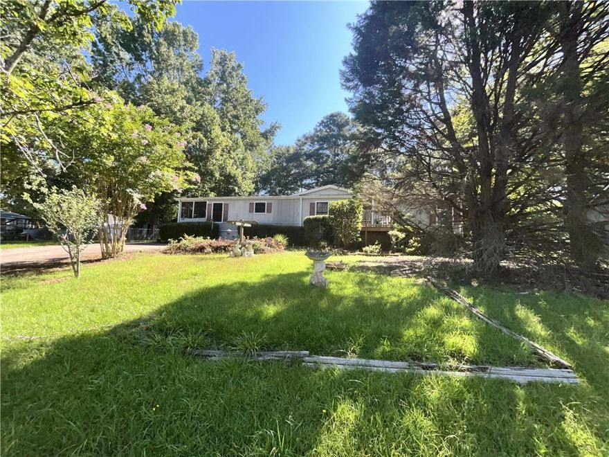 Double wide, 3 bedroom 2 bath with screened porch and detached 2 car garage/storage. Fenced in yard.