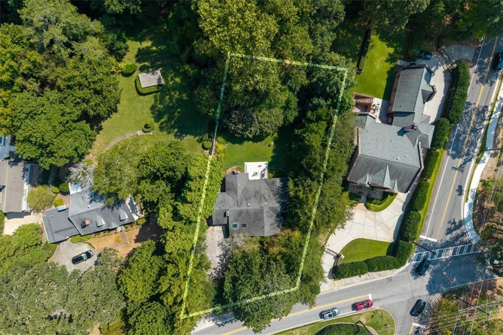 This inviting home can be enjoyed as-is, but its true value lies in the possibilities it offers—renovate, reimagine, or build your dream home from the ground up. Resting on just under a half-acre, the property boasts a rare, flat lot—an ideal foundation for creating beautiful indoor and outdoor living spaces. The home itself features two bedrooms and two full baths, including a true primary suite. A dedicated office provides the option to convert to a third bedroom, while abundant natural light, generous ceiling height, and two living areas with fireplaces create a comfortable, airy feel. Perfectly positioned in one of Sandy Springs’ most desirable neighborhoods, this property combines privacy with convenience—just minutes from top dining, shopping, and easy highway access. Whether you’re looking for a renovation project or the perfect site for new construction, 15 Mount Paran Road offers endless opportunity.