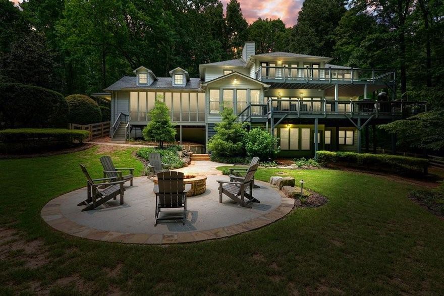 This stunning custom built Lake Front home boasts just over an acre of peace, privacy, and possibility, tucked away in desirable Cherokee County. Bordering Army Corps of Engineers property, you can rest assured there will be no new neighbors building nearby. Just moments from Eagle Watch Golf Club, Bridgemill Golf Club, premier nature trails and parks, highly rated schools, and shopping in Downtown Woodstock or at The Mill on Etowah. With no HOA restrictions, you can keep your boat parked in the yard, or at your dual level party dock. A short boat ride over to JD's on the Lake for dinner, formerly "Blue Cat Lodge", made famous by the Netflix series "Ozark", which the dual level party dock to this property had a cameo on! "Season 1, Episode 5"! This Lake Front dream features a total of seven bedrooms, which includes two Primary suites, one on the main-level, both with expansive decks and year round views of Lake Allatoona. The larger Primary suite upstairs is appointed with the most gorgeous views, complete with a spacious coffee bar, custom walk-in closets, an oversized double shower, beautiful soaking tub, and sitting area just awaiting your retreat. The unique bedroom off the upstairs Primary would make for a great nursery, office, or yoga studio with tranquil views. There are four bedrooms in total upstairs, all complete with a lake view, as well as a washer/dryer closet off the hallway. The impressive chef's kitchen ensures effortless hosting, giving way to the picturesque sun room, screened in back porch, and extensive decking, offering all seasons enjoyment with lake views. The professionally landscaped yard, stacked stone fire pit, and calming custom water feature solidify this backyard oasis as your family's forever sanctuary. Additional main-level features include a well-appointed mud-room with washer/dryer connections, a large light-filled office with built in bookcases, oversized dining room perfect for all the family gatherings, and a cozy sun drenched living room with a stately fireplace. The finished basement has a media room with fireplace, a wine room with built in cabinets, two large bedrooms, a full bathroom, and a spacious separate area for storing fishing poles, life jackets, seasonal decor, etc. The detached three car garage offers additional storage above. The double decker party dock is accessed via a short trail through the Army Corps of Engineers property. Secluded yet convenient, and a rare offering in Woodstock, come experience the endless possibilities Lake Life has to offer in this premier location!