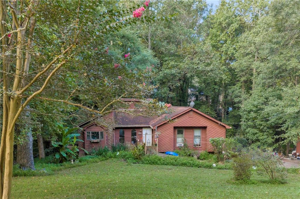 Investor Special - 4BR/3BA on Nearly 1 Acre in Gwinnett County! Cash buyers only! This 4-bedroom, 3-bath home sits on TWO LOTS - totaling 0.92 acres - in a sought after area of Gwinnett County in the Brookwood High School District. With a master on the main and a finished basement, there’s incredible potential to transform this property into a stunning primary residence, flip, or rental. This is an investor special - the home needs repairs and is priced accordingly. The spacious layout, large TWO lots, and finished basement offer great value for those ready to renovate. Call the listing agent for further details.