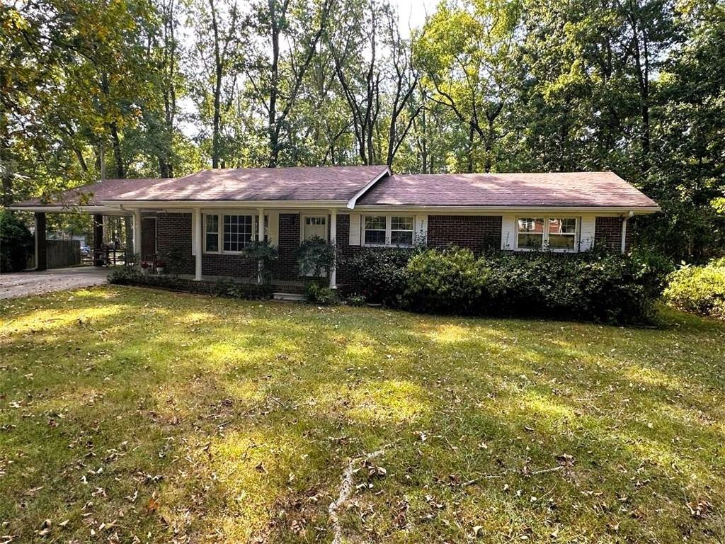 The location can not be beat in this traditional 4 sided brick ranch style home located in the heart of the city! This well built 3 BR 2 BA home situated on a level and private .57 acre lot comes with some recent updates including fresh interior paint, new LVP style flooring, and some new interior fixtures. Interior of the home features a large family room, separate dining area or den, a quaint kitchen, a large sunroom on the rear of the home, as well as a large laundry room. The primary bedroom features an attached bath, and the other 2 BR's are very spacious and accommodating as well. Located less than 1 mile to the Calhoun Primary & Elementary Schools, Advent Hospital, and I-75, and also very convenient to the downtown area and most all local restaurants, shopping, etc. This well built all brick stepless ranch home is just waiting on its new owner to make it their own!