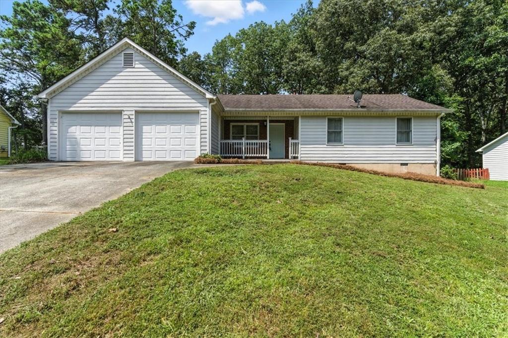 Renovated raised ranch on .51 acre: 3 beds, 2baths. Kitchen/dining have new LVP flooring. Kitchen features stainless appliances, granite, new cabinets and island; double doors open to large new deck and patio—ideal for entertaining. Vaulted ceilings in family/dining rooms with fireplace and hardwood floors elsewhere. One-level layout suits down-sizers or first-time buyers. Level wooded yard, fenced, with attached 2-car garage. Walk or drive to vibrant Downtown Woodstock, featuring the amphitheater, trendy shops and restaurants. Access the Greenprints Trail along Noonday Creek to Woodstock Dog Park and Towne Lake. Close to Blankets Creek, Hobgood Park and Lake Allatoona. Zoned Boston Elementary, E.T. Booth Middle and Etowah High.