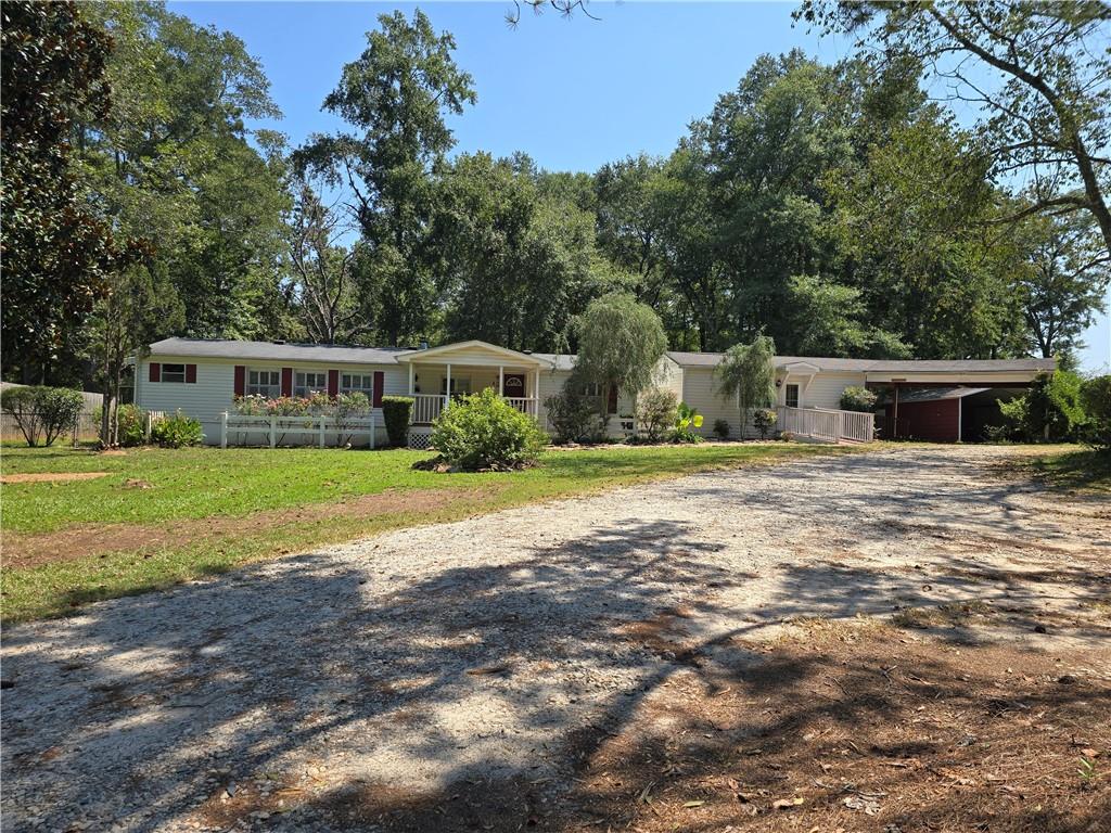 Gated, single-level manufactured home on 8.43 acres. A private drive opens to a well-manicured front yard, with multiple storage buildings and sheds spread across the property—ideal for tools, equipment, toys, and on-site workspace.
Inside, the home’s single-story layout keeps life easy. Wheelchair accessible entrance, open living/dining flow, comfortable bedrooms, and simple access to the outdoor areas. Covered back patio is perfect for entertaining or having your morning cup of coffee. Schedule your tour today!