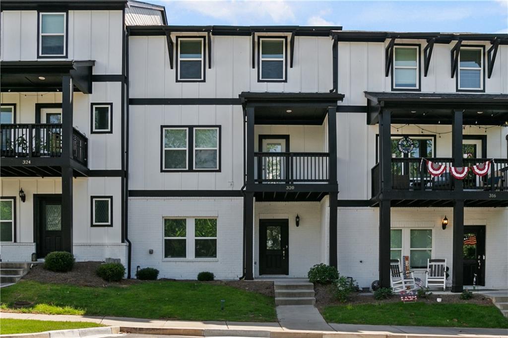 Gorgeous townhome in the perfect location! Close to shopping, dining, walking trails, downtown Woodstock and 575. This townhome features 3 stories, entering into the lower level featuring a bedroom, full bathroom and 2 car garage with opener. Heading upstairs to the main level, you'll find an open, spacious floorplan with luxury vinyl plank flooring throughout. The kitchen features a large island, light grey cabinetry, beautiful backsplash, large pantry and stainless appliances including double ovens, microwave, gas cooktop and dishwasher. The kitchen is flanked by the great room and dining room. The main level also features a half bath and closet. There is a covered front deck off the dining area. Heading upstairs, you'll find three bedrooms, including the owner's suite with large closet. The owner's bath has an oversized, tiled shower and double vanities. There are two secondary bedrooms and a full bath with double vanity and tub/shower. The laundry room is also on the upper level. Window treatments throughout home and move-in ready. Enjoy easy living in this energy efficient townhome and relax by the community pool.