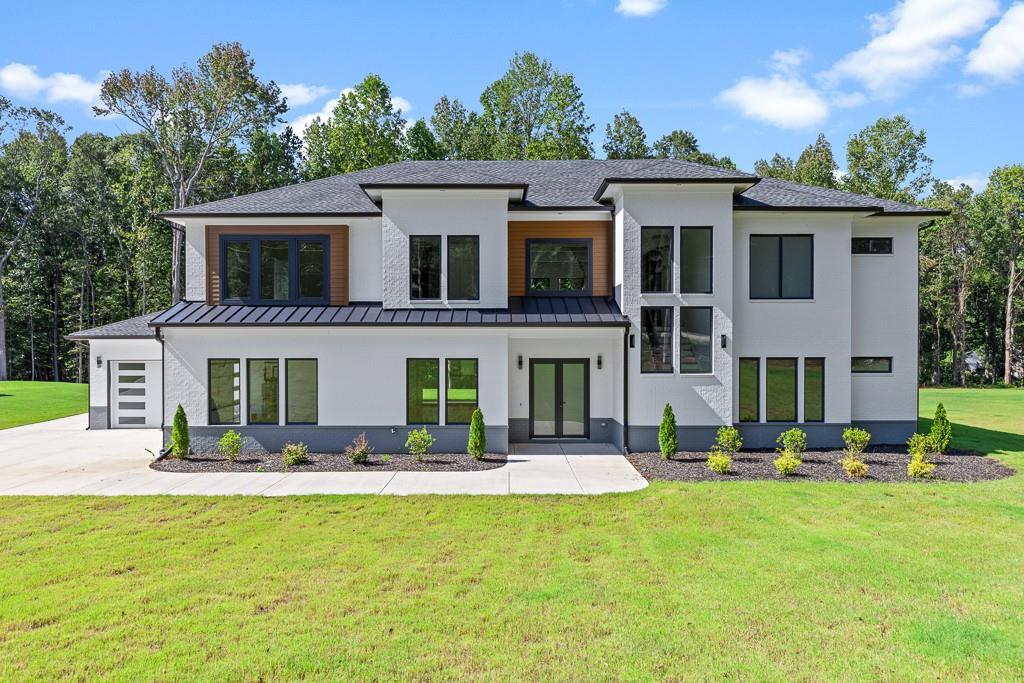 This stunning country "estate" sits proudly on acre-plus lot with over 500' of road frontage. Dramatic soaring ceilings and HUGE fixed windows and slider doors create allow for incredible natural light. The kitchen is well-appointed with custom cabinetry, massive quartz island, and Cafe appliances. AND... a scullery with more cabinets, preparation space, second dishwasher, cooktop and sink! Junior primary suite on main level has second laundry location in the large walk-in closet. Office/study on main has bookshelves and cabinetry. Wonderful outdoor space includes enormous covered patio and very level back yard. Massive loft on second level with built-ins and floating shelves. This is the perfect kid hang-out or TV room. Primary suite features sexy bathroom with wetroom. Engineered wood floors throughout! No carpet anywhere. All bathrooms include full showers with beautiful marble tile walls and floors. Statement light fixtures throughout. All closets have systems. No wire shelving anywhere! Spray foam insultion. Builder inclues a 2/10 Homebuilder's warranty. This could be the one! So much value when you compare other new construction price per sqaure foot.