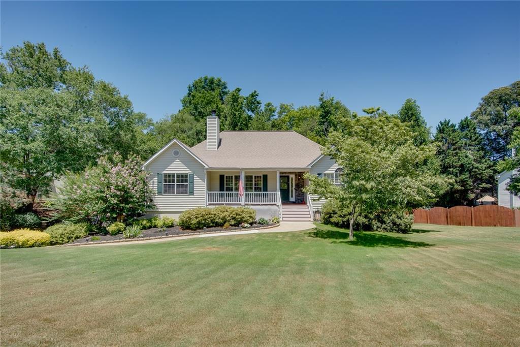 Welcome to this charming RANCH home with a fully finished basement, offering the perfect blend of comfort and entertainment space. Upon arrival, you are welcomed by a rocking chair front porch perfect for peaceful fall and spring evenings. Inside, the home features elegant bamboo wood floors throughout and an open floorplan that creates a spacious feel. The updated kitchen seamlessly connects to a large den with a stacked stone wood-burning fireplace and a separate dining room and a relaxing deck off the kitchen are perfect for entertaining! The primary bedroom boasts two generous closets and a beautifully renovated en-suite bathroom complete with a standalone soaker tub!  Situated on the opposite side of the home for privacy, two additional bedrooms share a secondary bathroom, with one bedroom featuring a sizable walk-in closet. The full finished basement adds considerable living space, complete with an additional bedroom, full bathroom, a versatile rec room or living area, and ample storage options. Outside, discover a meticulously landscaped backyard oasis perfect for outdoor activities, featuring patio space under the deck and a serene firepit area. This home is a true gem, so don’t hesitate to schedule your showing soon — it won’t stay on the market for long!