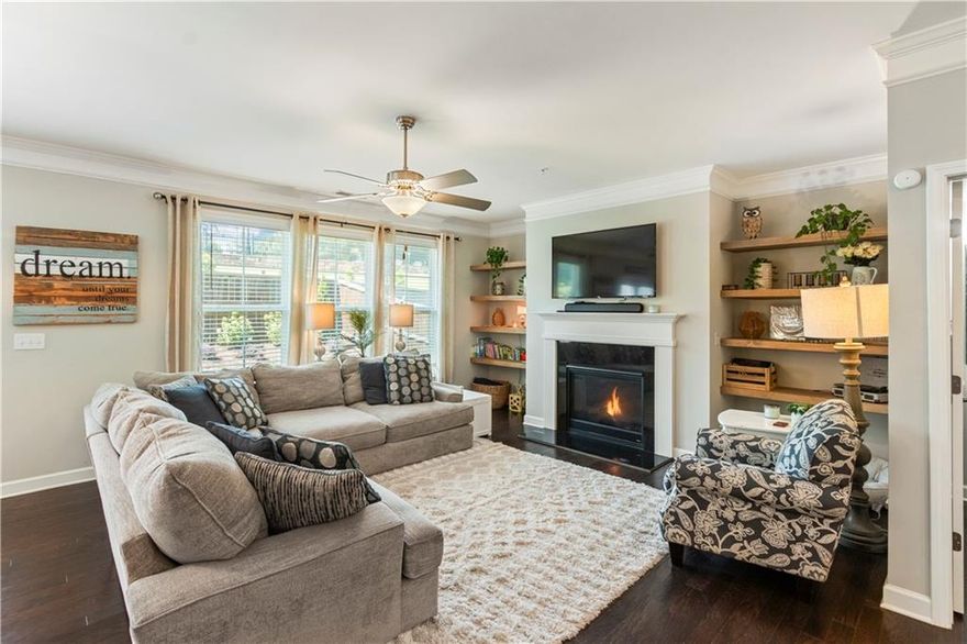 Welcome to Hedges Park, just a short stroll to all the shops, dining & events at Marietta Square! This move-in ready beauty exudes the comfort and style you’ve been searching for! When you step inside, you’ll be greeted by warm, espresso-colored wood floors that flow throughout the lower level. The open concept gourmet kitchen is truly the heart of the home, featuring a spacious breakfast area, stainless steel appliances, wall oven with convection microwave, granite countertops, abundant cabinets, walk-in pantry & separate dining area. The family room adds its own appeal with custom shelves for your decor or your own library for avid readers and the gas fireplace makes it easy to cozy up on the couch with a cup of coffee or glass of wine (cheers!) and just in time for fall. The wall of windows overlooks the private fenced back yard that was recently landscaped & offers plenty of space for entertaining guests, grilling, play time or running room for your fury friends! Upstairs you will find 3 carpeted bedrooms & 2 full tiled bathrooms and a separate laundry room. The owners suite offers abundance of space, style & comfort with beautiful tray ceiling, wall of windows where natural sunlight flows and the bathroom features double vanities, soaking tub, walk-in tiled shower and large walk-in closet. HOA maintains the lawns year round. And did I mention this is near the lively Marietta Square? Buckle up buttercup, because this lovely home is where charm, comfort, and convenience come together, all within walking distance on the trail from the home straight to shopping, dining, museums, theaters, farmers markets, art shows, parks, trails, outdoor concerts, and more! Welcome Home!