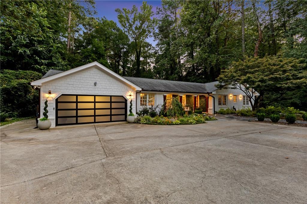 Newly renovated classic English ranch reimagined with modern luxury, this 4-bedroom, 2.5-bath home offers nearly 3,000 square feet of thoughtfully designed living space on a half-acre lot located 5 mins away from the Perimeter Mall. The oversized owner’s suite features a cozy fireplace and a spa-inspired bath with elegant finishes, while the light-filled chef’s kitchen showcases an oversized Cambria quartz island, premium appliances, and open flow for entertaining. With four spacious bedrooms and a dedicated office, the home strikes a balance between comfort and functionality, thanks to abundant natural light throughout. Outdoor living shines with a brand-new cedar pergola, white marble pavers, a tranquil Zen fountain, and a fully equipped outdoor kitchen complete with grill, refrigerator, and beer tap—perfect for gatherings. Both the front and backyard have been fully landscaped with upgraded plantings, highlighted by a mature Japanese maple tree and vibrant flowers designed to attract butterflies. Every detail of this renovation has been carefully curated to blend charm, elegance, and modern convenience. Move-in ready and waiting for its next chapter.