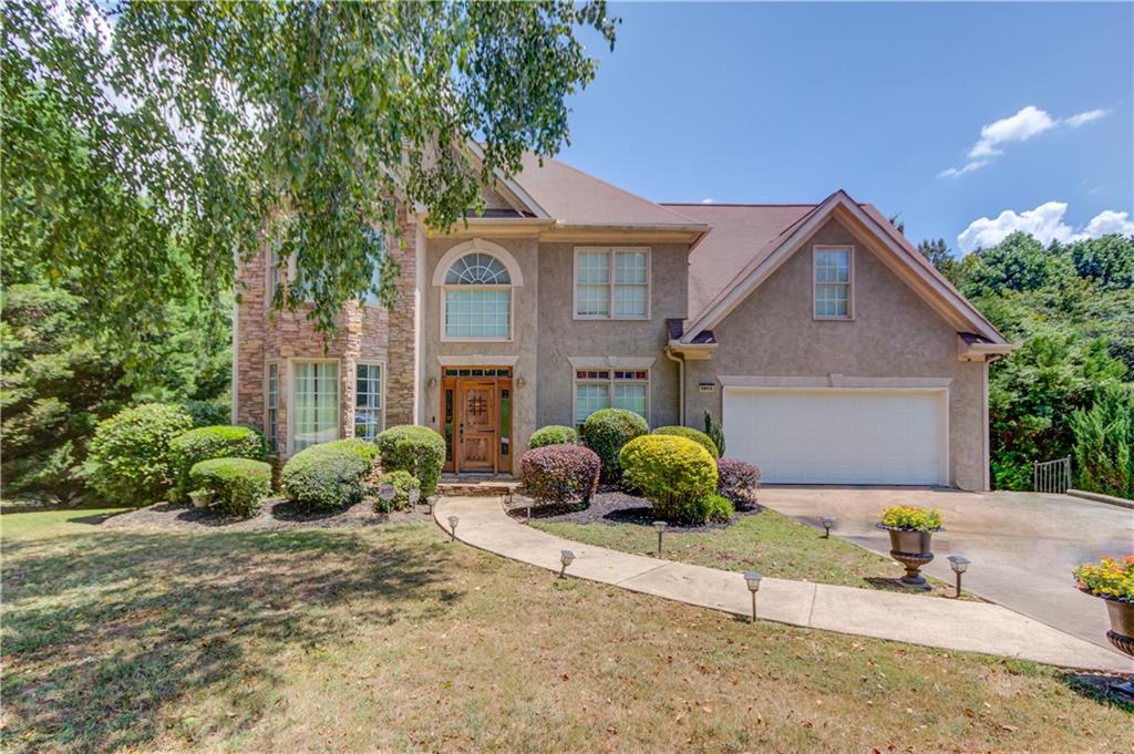 Welcome to this light-filled 5-bedroom, 3.5-bath home designed for comfort, versatility, and entertaining. Step inside to a dramatic two-story foyer and living room that create an open, airy feel. The main level features a flex space perfect for a home office or playroom, a separate dining room for formal gatherings, and a bright breakfast area with a breakfast bar overlooking the kitchen. Enjoy cooking in the kitchen outfitted with new stainless steel appliances and flowing into the living area—both along with upstairs recently updated with luxury vinyl plank (LVP) flooring for a stylish, low-maintenance touch. Upstairs, you'll find generously sized secondary bedrooms and a large primary suite with a private sitting room—ideal for unwinding after a long day. The finished walkout basement includes a full second kitchen, laundry area, full bathroom, bedroom with 2 additional rooms ready for a workout room, playroom, home office - so many possibilities and it has a private entrance—perfect for multi-generational living or potential rental income. Outside, the fenced, level backyard is beautifully landscaped and features a generous deck—ideal for weekend BBQs and gatherings. The front yard features professional landscape uplighting, adding curb appeal and charm after sunset.  Located in a welcoming, well-maintained neighborhood, this home is move-in ready and offers flexible living options to fit your lifestyle.