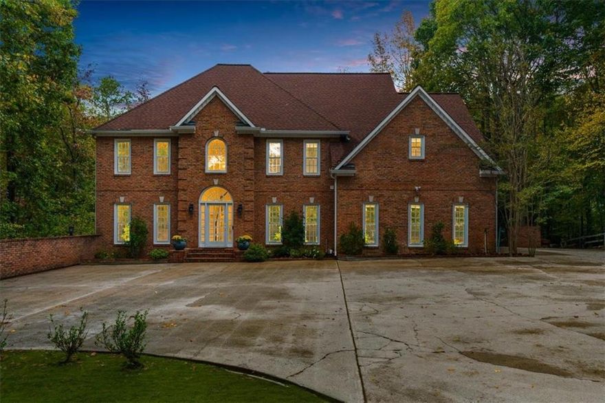 Your Private Roswell Retreat Awaits!

Discover the perfect blend of luxury, privacy, and convenience in this stunning 5-bedroom, 4.5-bath custom home, beautifully renovated from top to bottom and nestled on over 3 acres in the heart of Roswell. Tucked away on a private paved drive, this home feels like your own secluded oasis—yet you’re only minutes from downtown Roswell’s shops, restaurants, and entertainment.

Step into the impressive two-story foyer, where natural light and elegant finishes immediately set the tone for this exceptional property. The main floor offers a private office with floor-to-ceiling built-in bookshelves, a formal dining room, and a beautiful sitting room perfect for entertaining or quiet conversation.

The soaring two-story great room, anchored by a cozy fireplace, opens to a bright and inviting kitchen. Featuring a custom island, stainless steel appliances, and a sun-filled breakfast nook, this kitchen is truly the heart of the home. From here, enjoy easy access to the expansive back deck overlooking the private fenced yard and serene wooded acreage beyond—ideal for entertaining or relaxing in nature.

Upstairs, the primary suite is a luxurious escape. The renovated primary bath offers a soaking tub, dual vanities, and a stunning custom shower. The walk-in closet is simply spectacular! It is an absolutely breathtaking space that’s as functional as it is beautiful.Two additional bedrooms and two fully renovated baths complete the upper level, providing comfort and sophistication for family or guests.

The finished terrace level is designed for versatility and entertainment, featuring a large recreation room, gym, theater, or guest suite, with an additional full bath and office space that could double as another bedroom. Step outside to the covered patio with waterproof underdecking that overlooks the heated gunite pool (resurfaced in 2022), surrounded by a gorgeous flagstone patio that creates the perfect resort-style setting.

This home has been meticulously cared for and thoughtfully upgraded, including a whole-house generator, upgraded well pump, two whole-house dehumidifiers, new gutters, new HVAC, Moen whole-home water monitoring system, and new basement flooring. With no HOA, unmatched privacy, and a location that offers the best of both worlds, this property is truly one of a kind.

This rare retreat truly has it all—luxury, privacy, and location. Welcome home.