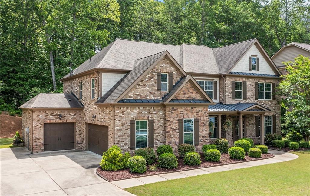 PRICED TO SELL. Welcome to your dream home in the highly desirable Silveroak community of Acworth! This lovely executive 4-sided brick home at 3752 square feet sitting on .79 of an acre, combines timeless elegance with modern comfort, offering 5 spacious bedrooms plus a versatile bonus/media room that can serve as a 6th bedroom. From the moment you step inside, you’ll notice the details that set this home apart: gleaming hardwood floors, a formal dining room crowned with coffered ceilings, and an inviting open-concept living space anchored by a stacked stone fireplace with custom built-ins. The heart of the home—the gourmet kitchen—is designed for both chefs and entertainers alike, boasting granite countertops, stainless steel appliances, double ovens, and a generous island perfect for gathering. The main level also offers thoughtful touches, including a private office with French doors and a guest suite ideal for visitors or multi-generational living. Upstairs, retreat to the oversized primary suite, complete with a cozy sitting area, double-door entry, and a spa-inspired ensuite bath. Secondary bedrooms are bright and generously sized, while the bonus/media room provides endless possibilities—whether a home theater, playroom, or additional bedroom. Step outside and you’ll fall in love with the covered patio oasis, featuring a wood-burning fireplace and views of the tranquil backyard—perfect for year-round relaxation and entertaining. Recent updates, including a new HVAC system (2023), add peace of mind, while the Silveroak neighborhood elevates your lifestyle with swimming, tennis, and direct access to the scenic Allatoona Creek Trail System. This home offers the perfect blend of style, space, and location—ready for the next owner to create lasting memories.
