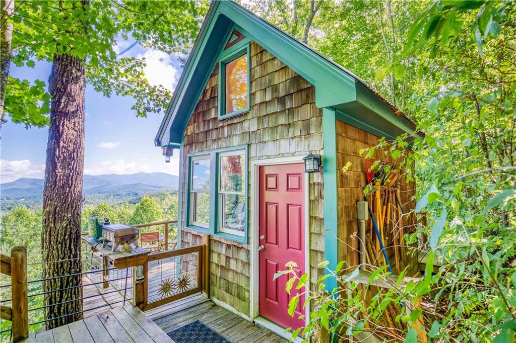 Welcome to your own piece of paradise! This property offers unparalleled mountain views that stretch over 20 miles. This charming cabin is ideal for a weekend getaway, or you could build your dream mountain home here, as a septic system is already installed. Imagine enjoying your morning coffee on the oversized back deck while watching eagles soar overhead. This is an amazing property you won't want to miss!